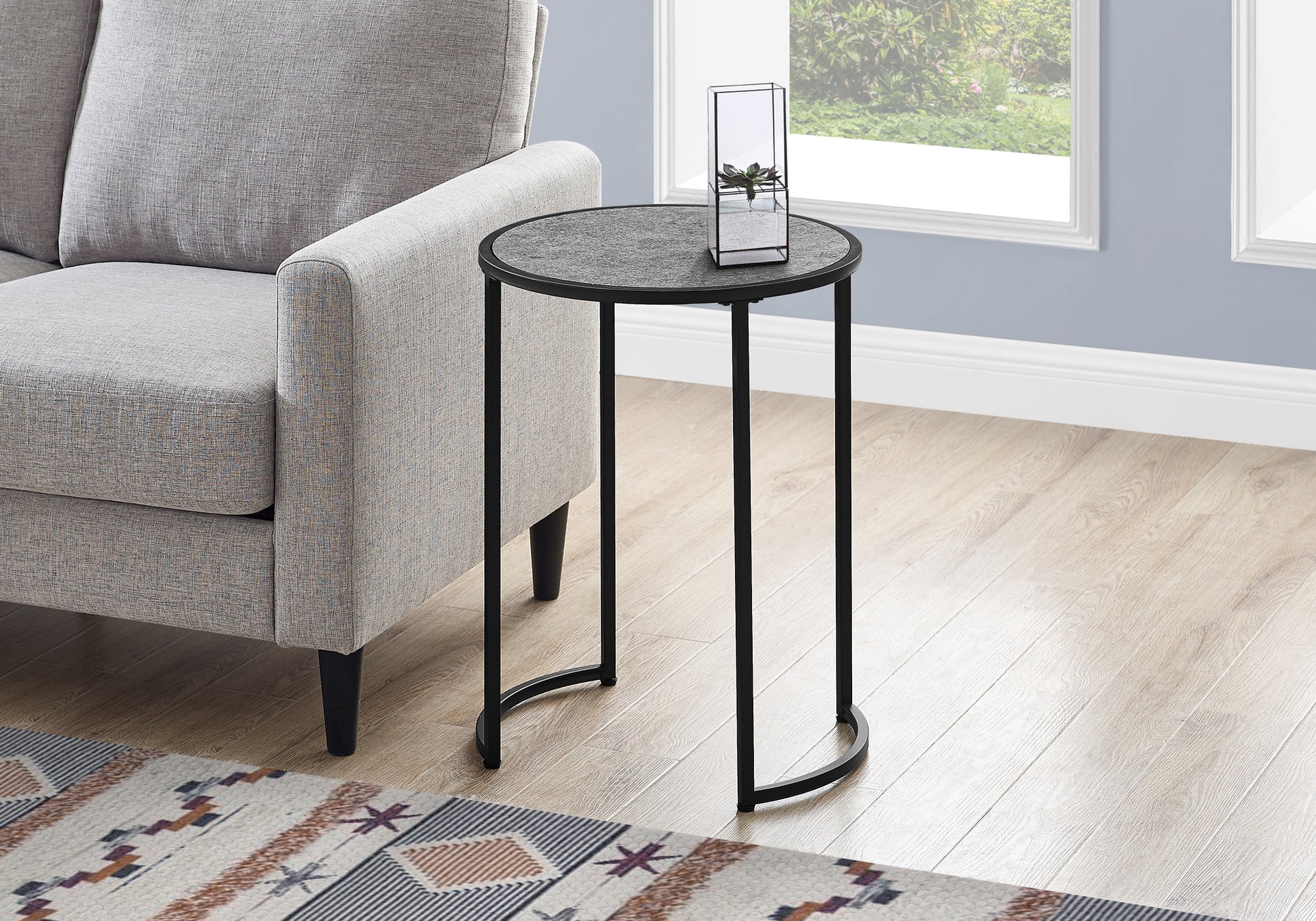 Round charcoal gray end table with black metal frame perfect for small spaces