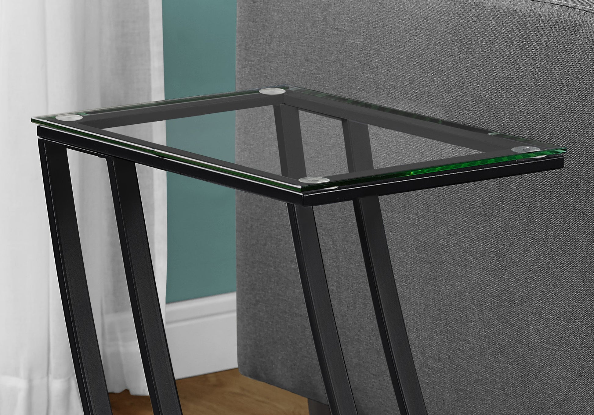 Sleek Ctable with clear tempered glass top and black metal frame perfect for small spaces