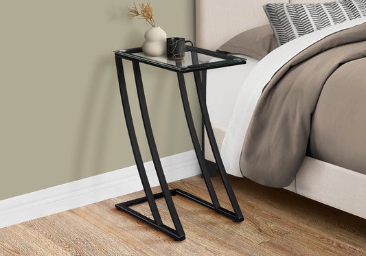 Sleek black metal ctable with clear glass top perfect for bedside use