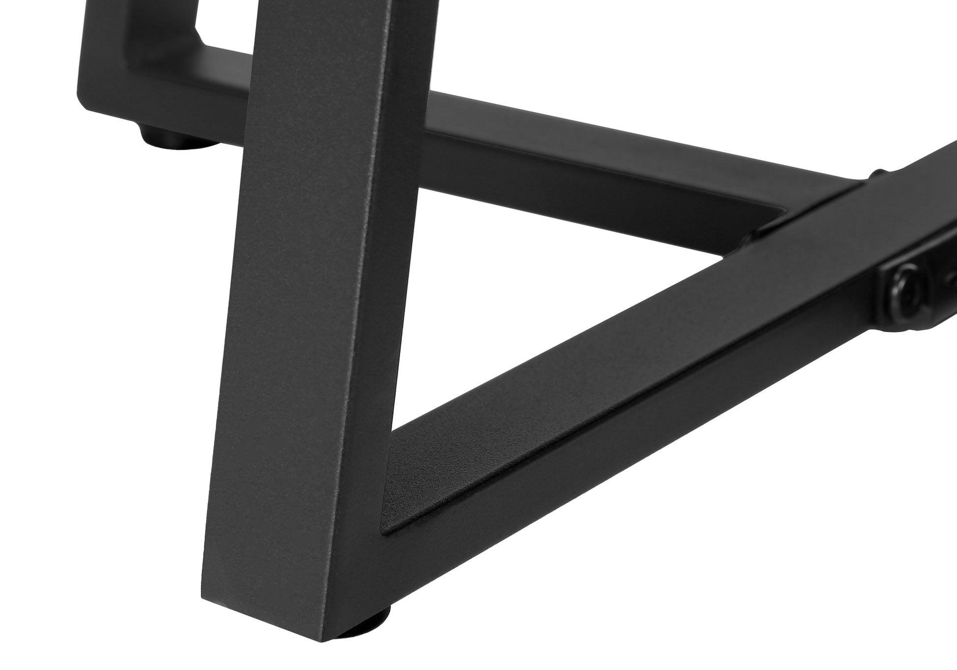 Closeup of black metal table legs with modern angular design