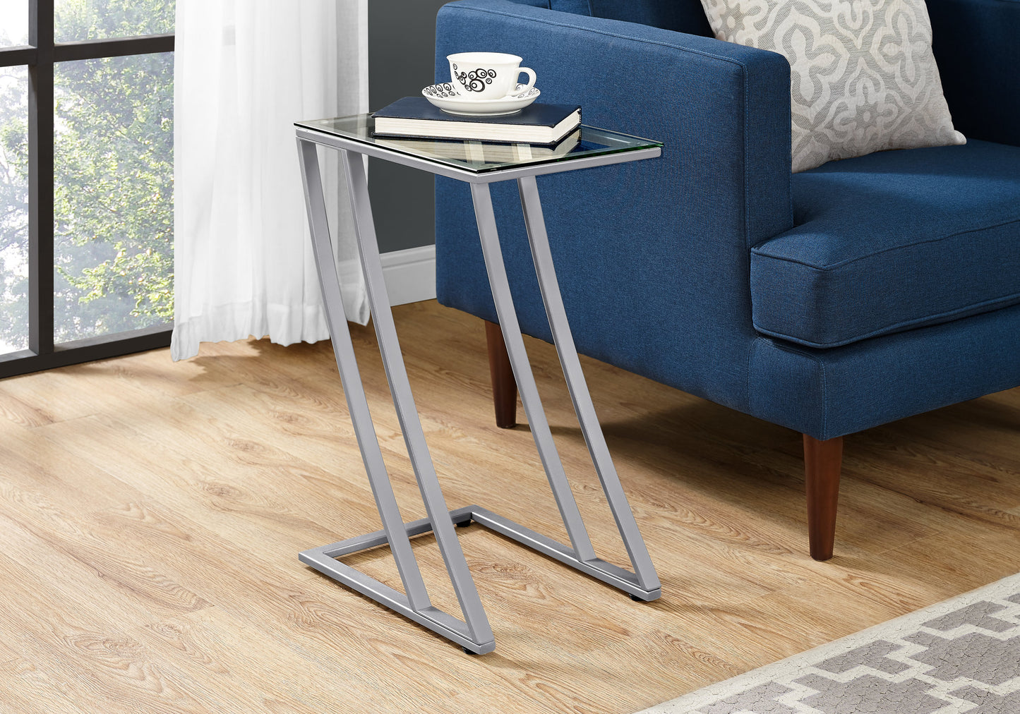 Modern Ctable with clear glass top and silver metal frame ideal for living rooms