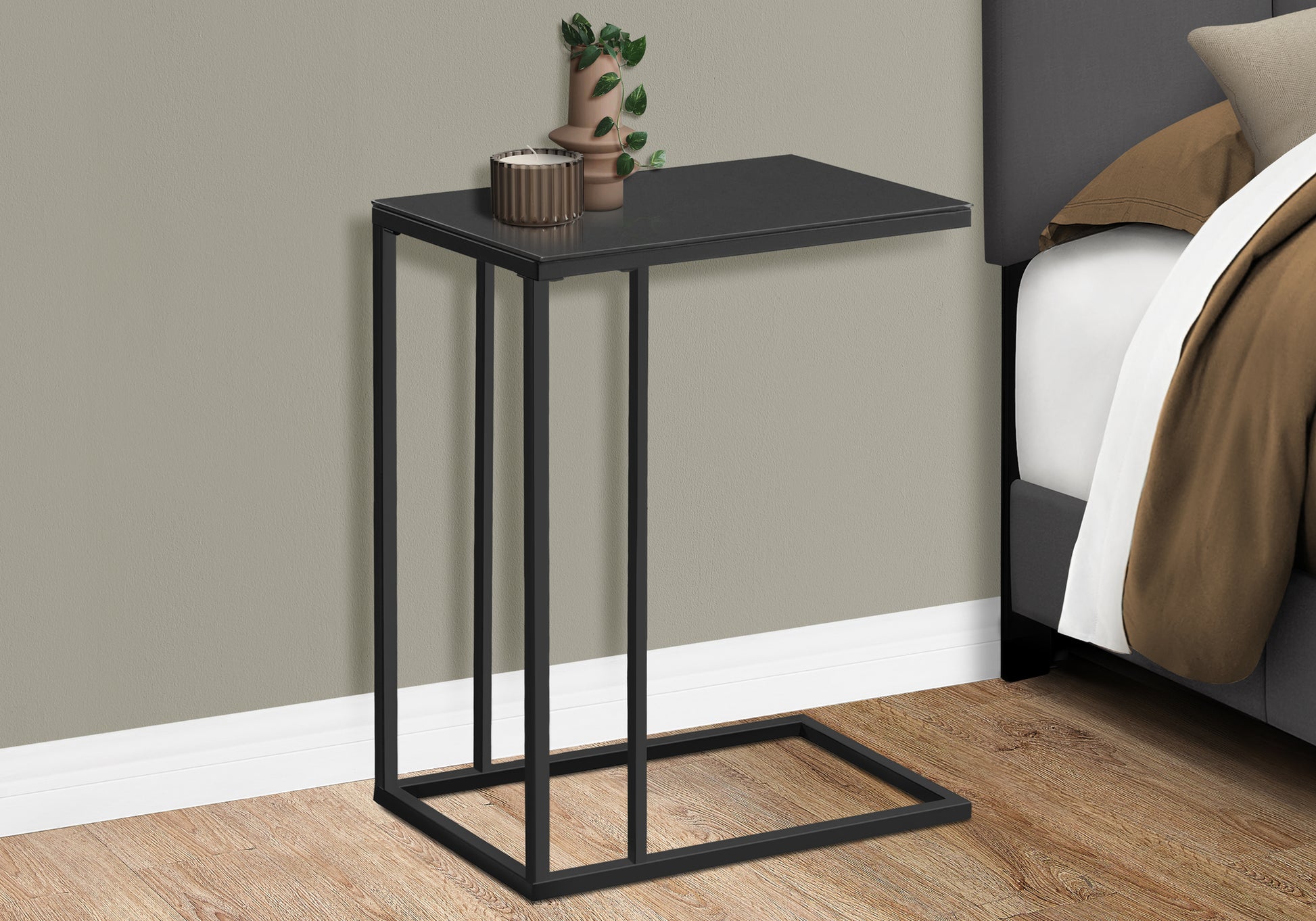 Sleek black metal Ctable with a thin rectangular top perfect for bedside use