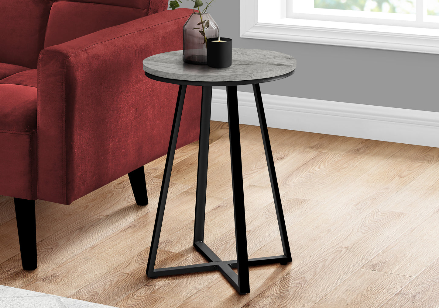 Round gray wood grain end table with black metal legs ideal for small spaces