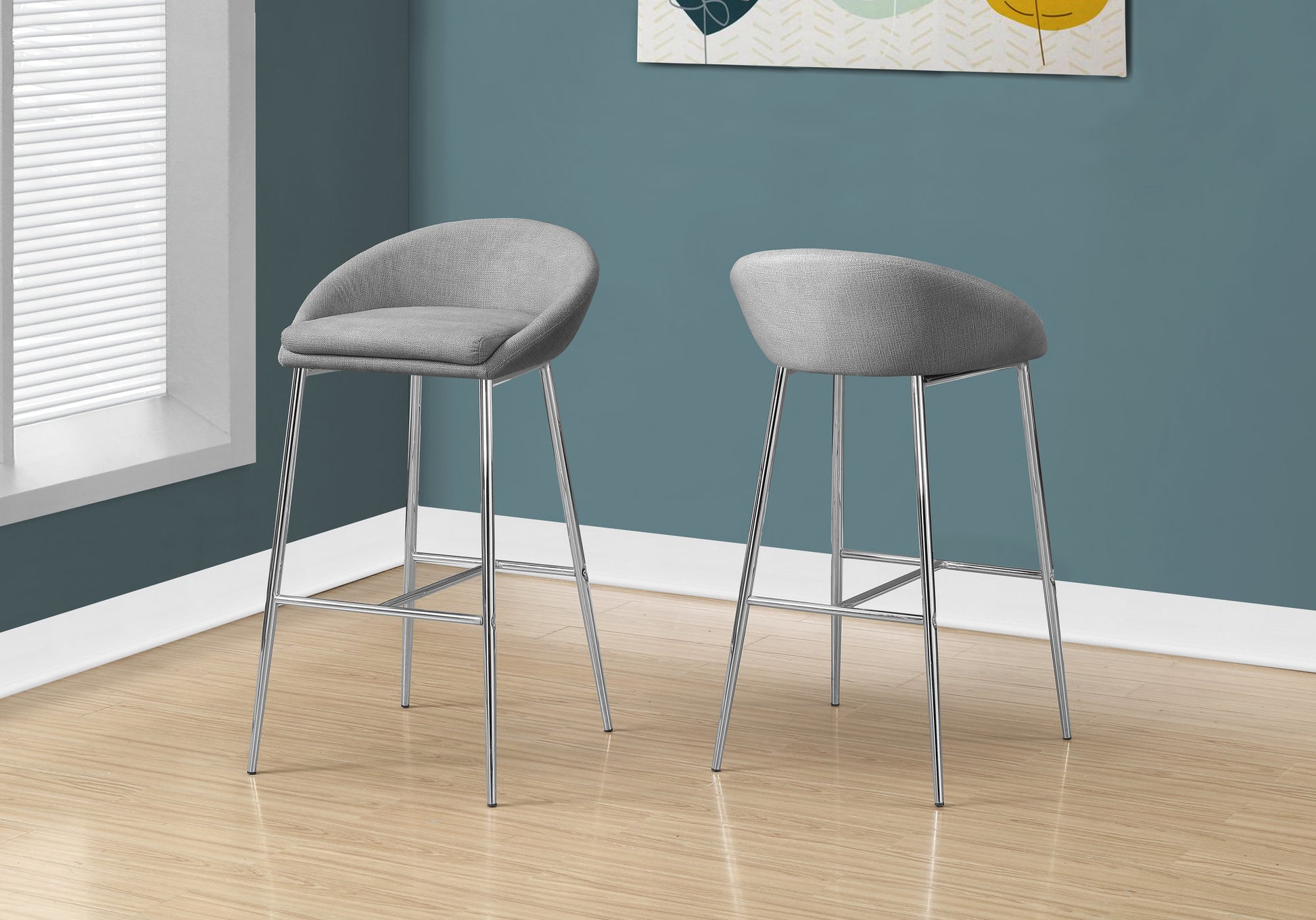 Gray upholstered bar stools with sleek chrome legs