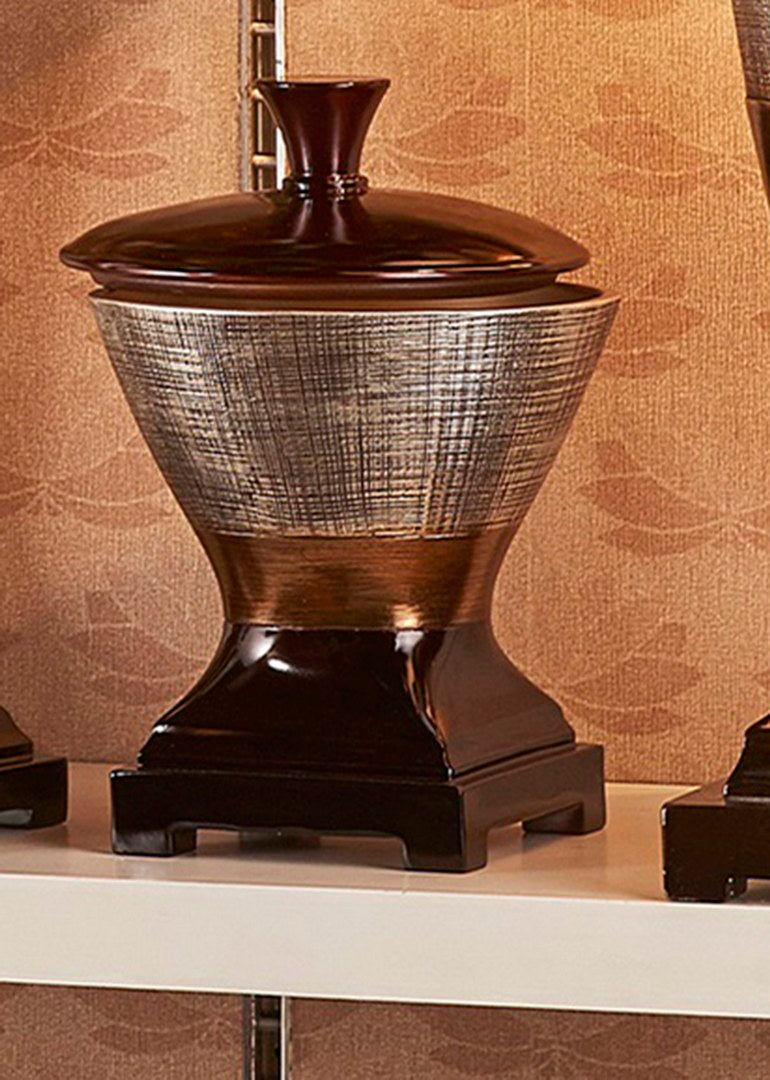 Dark brown lidded decorative urn with textured silver and bronze body