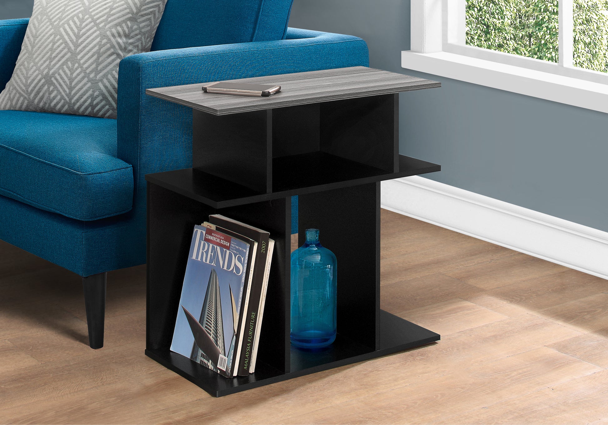 Modern black Ctable with grey wood grain top holds a smartphone