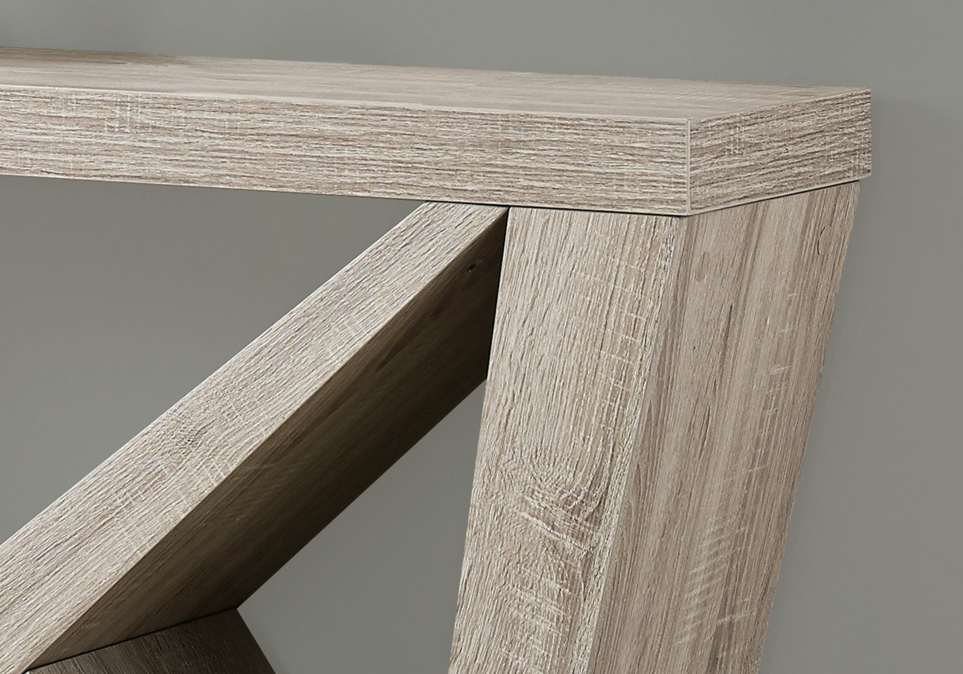 Closeup of rustic oak wood grain texture on a modern console table leg