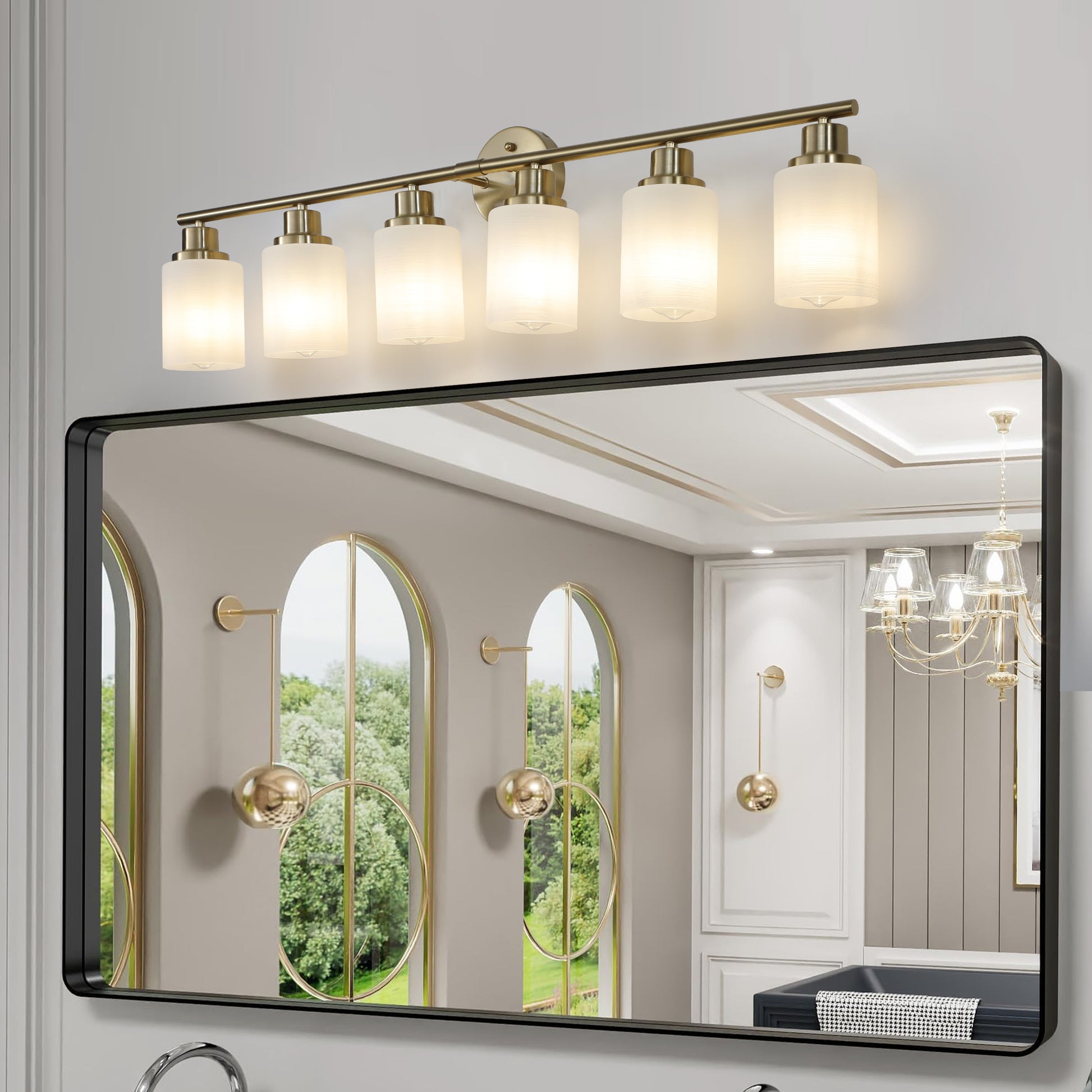 Modern brass vanity light fixture with five frosted glass shades above a black framed mirror
