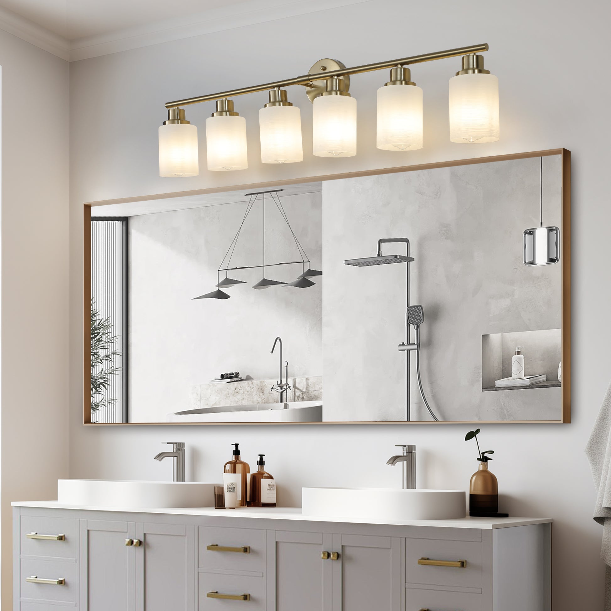 Modern brass vanity light fixture with six frosted glass shades above a bathroom mirror
