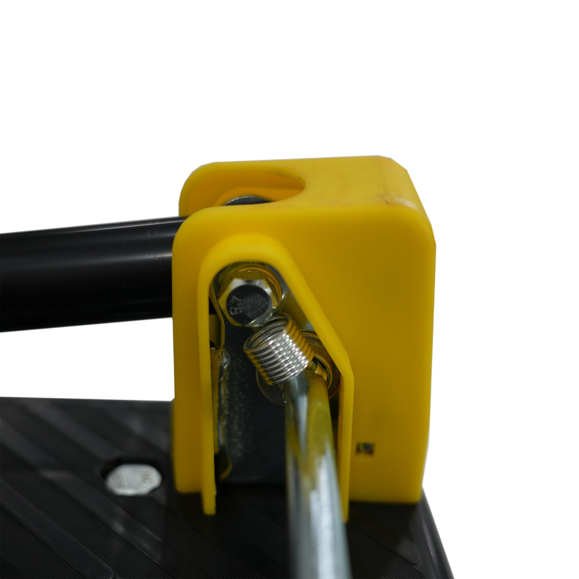 Closeup of the yellow mechanism and spring on a black dolly cart