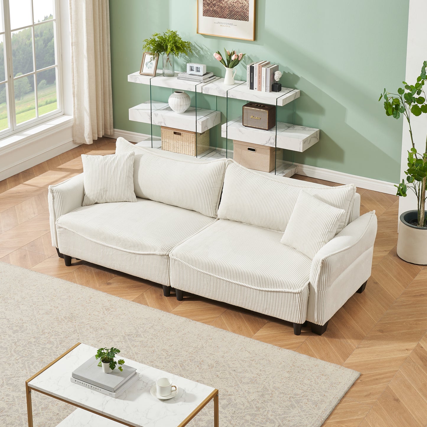 Plush ivory corduroy sofa with matching throw pillows and dark wood legs perfect for modern living rooms
