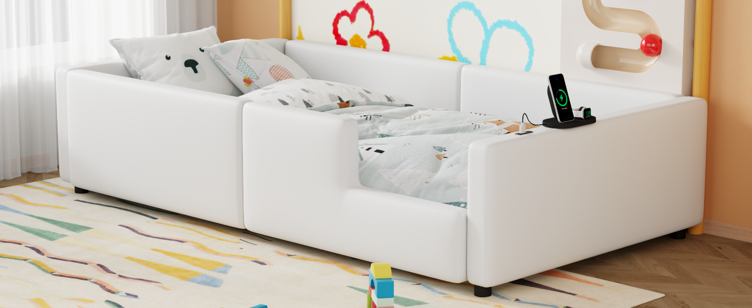 White toddler bed with protective rails and cute animal pillows on a colorful rug
