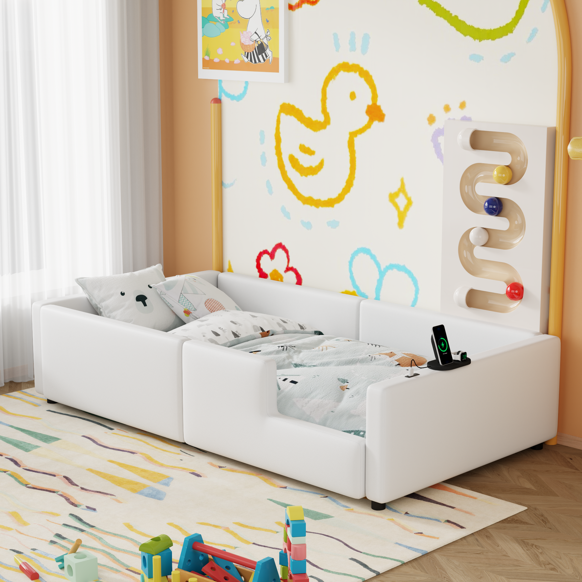 White toddler bed with playful wall art and builtin ball ramp ideal for nursery