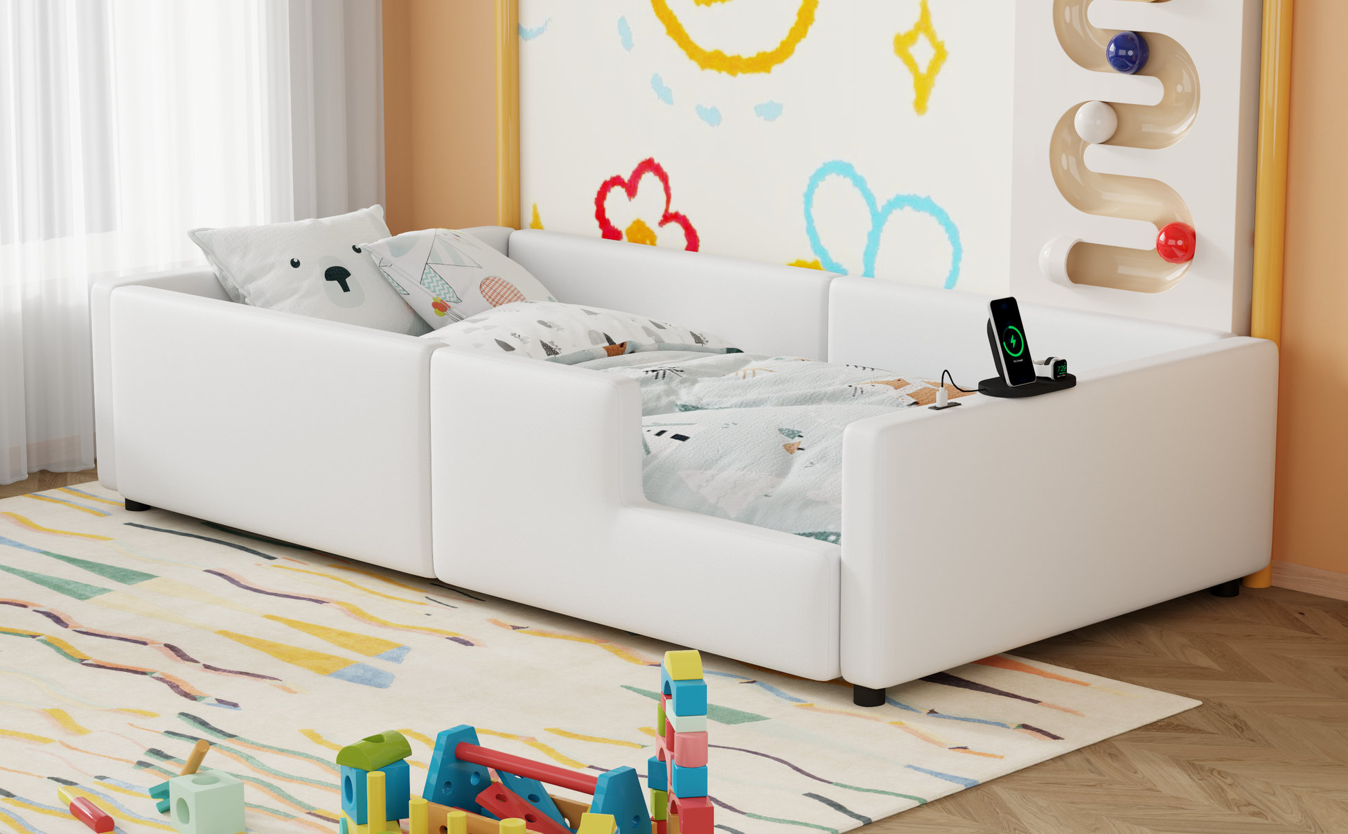 White toddler bed with playful animal print bedding and integrated charging station