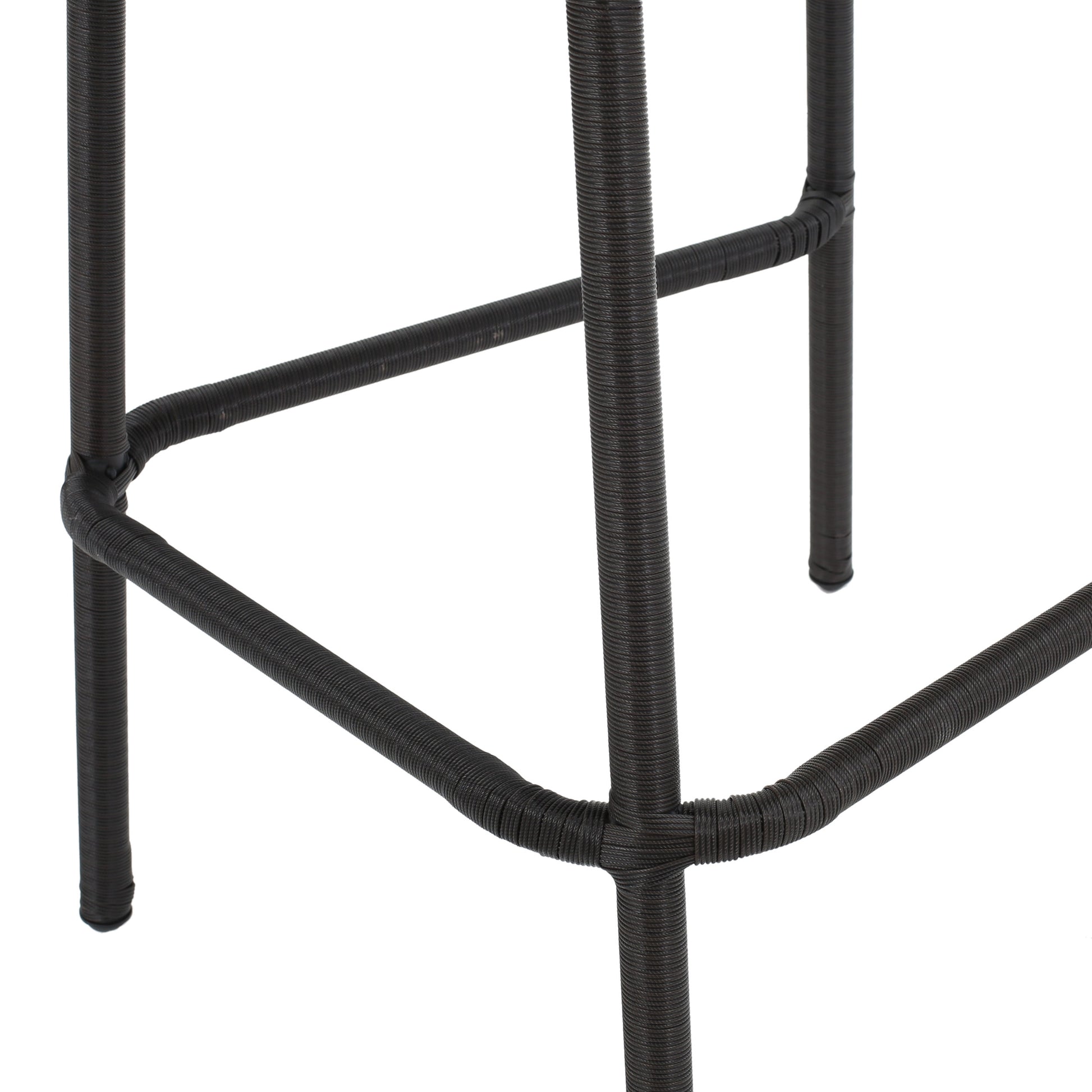 Closeup of dark brown woven rattan bar stool base with metal frame support