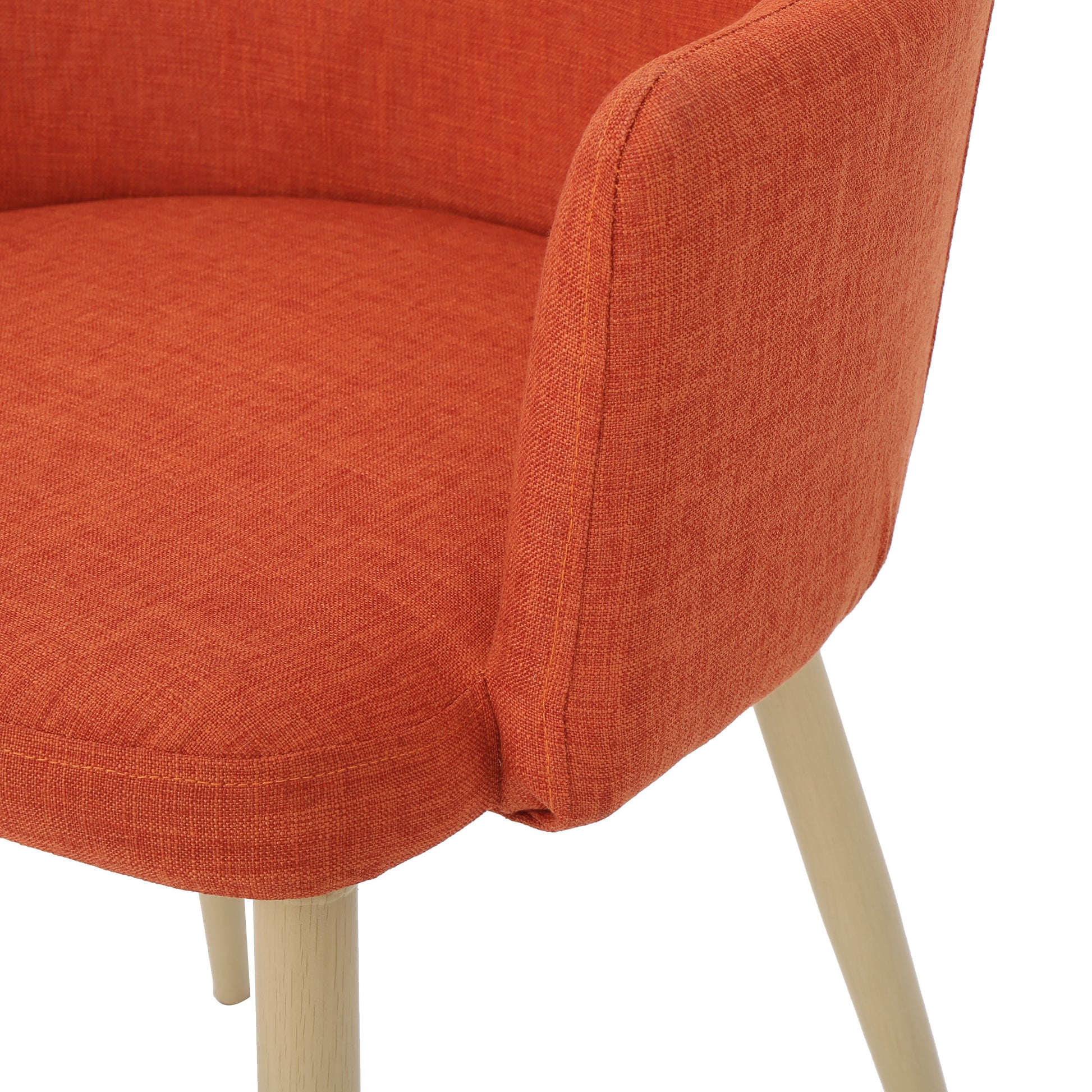 Closeup of an orange fabric accent chair with light wood legs