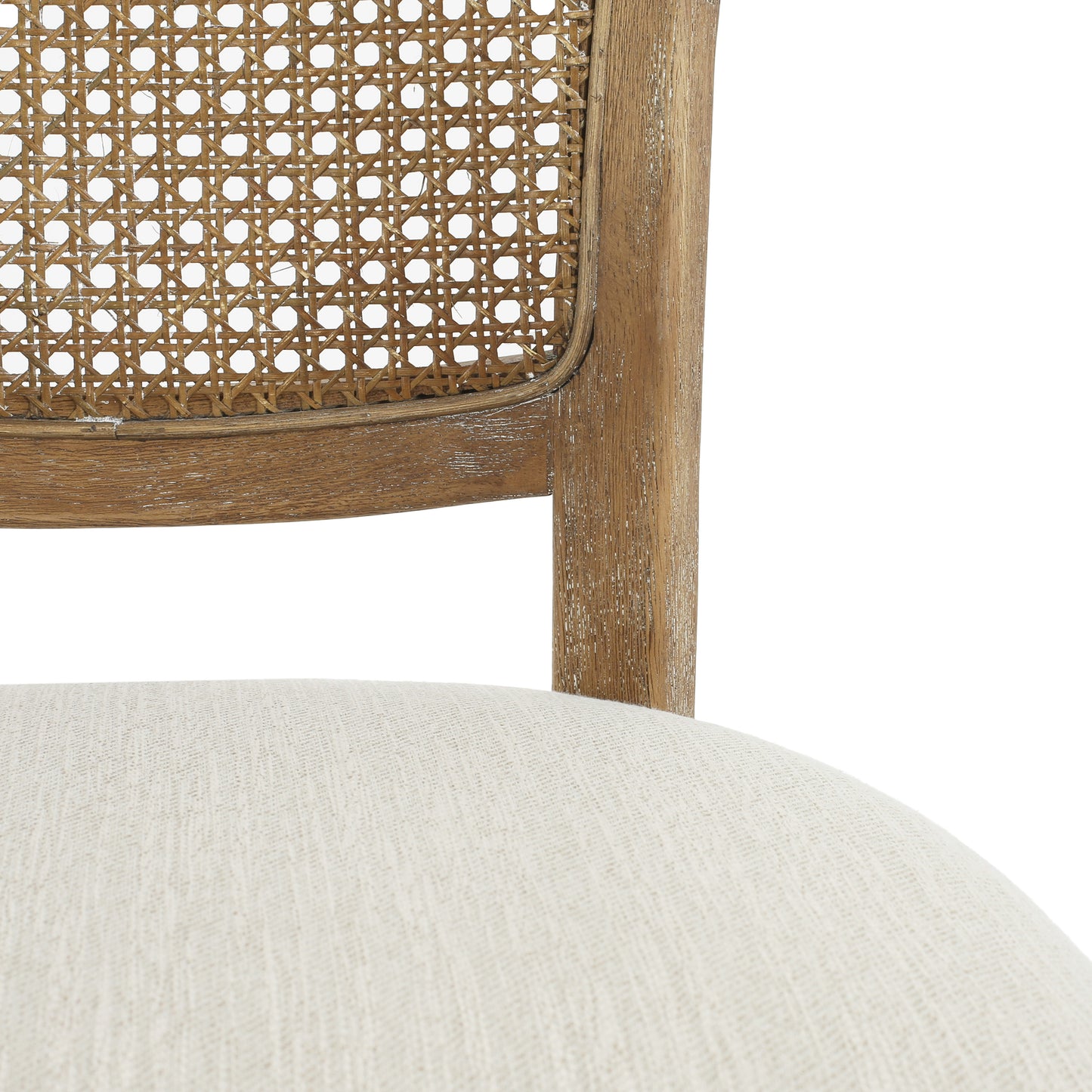 Natural cane back chair with a light fabric seat and weathered wood frame