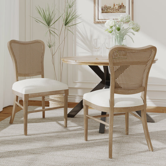 Two light wood cane back dining chairs with cream upholstered seats