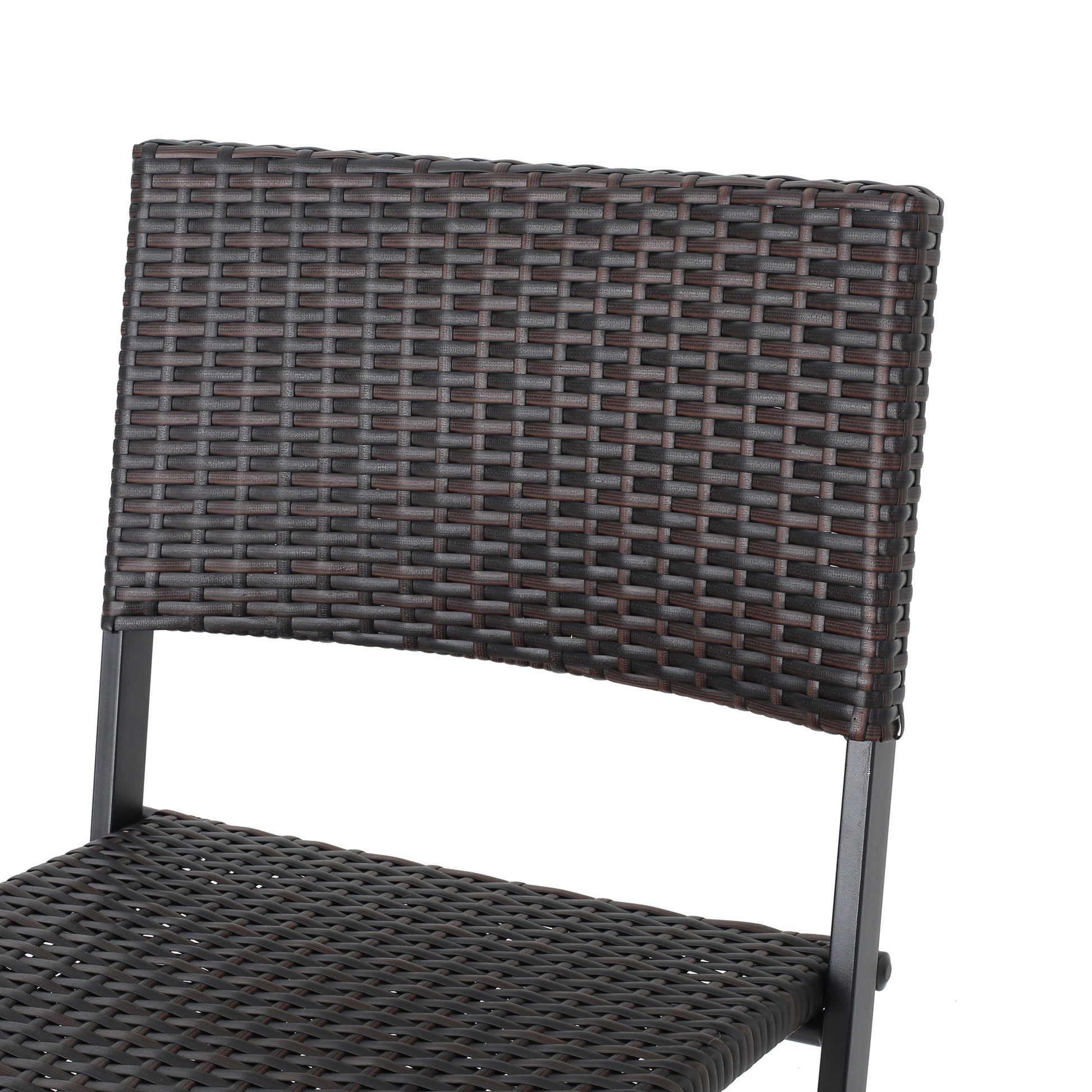 Closeup of a brown wicker chair back with a dark metal frame