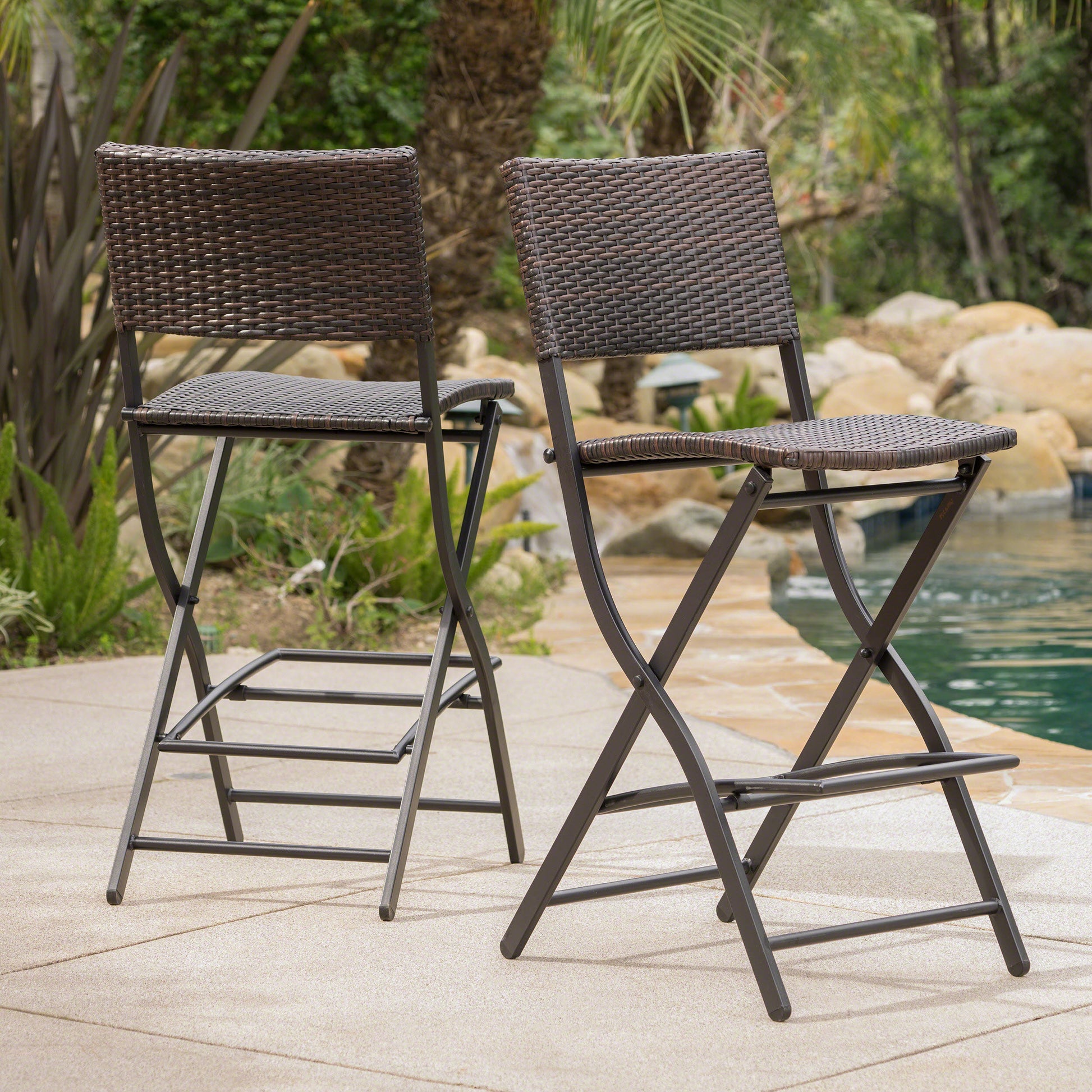 Brown wicker outdoor bar stools with dark metal frames perfect for patio seating