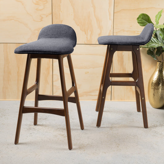 Two upholstered charcoal grey bar stools with dark wood legs