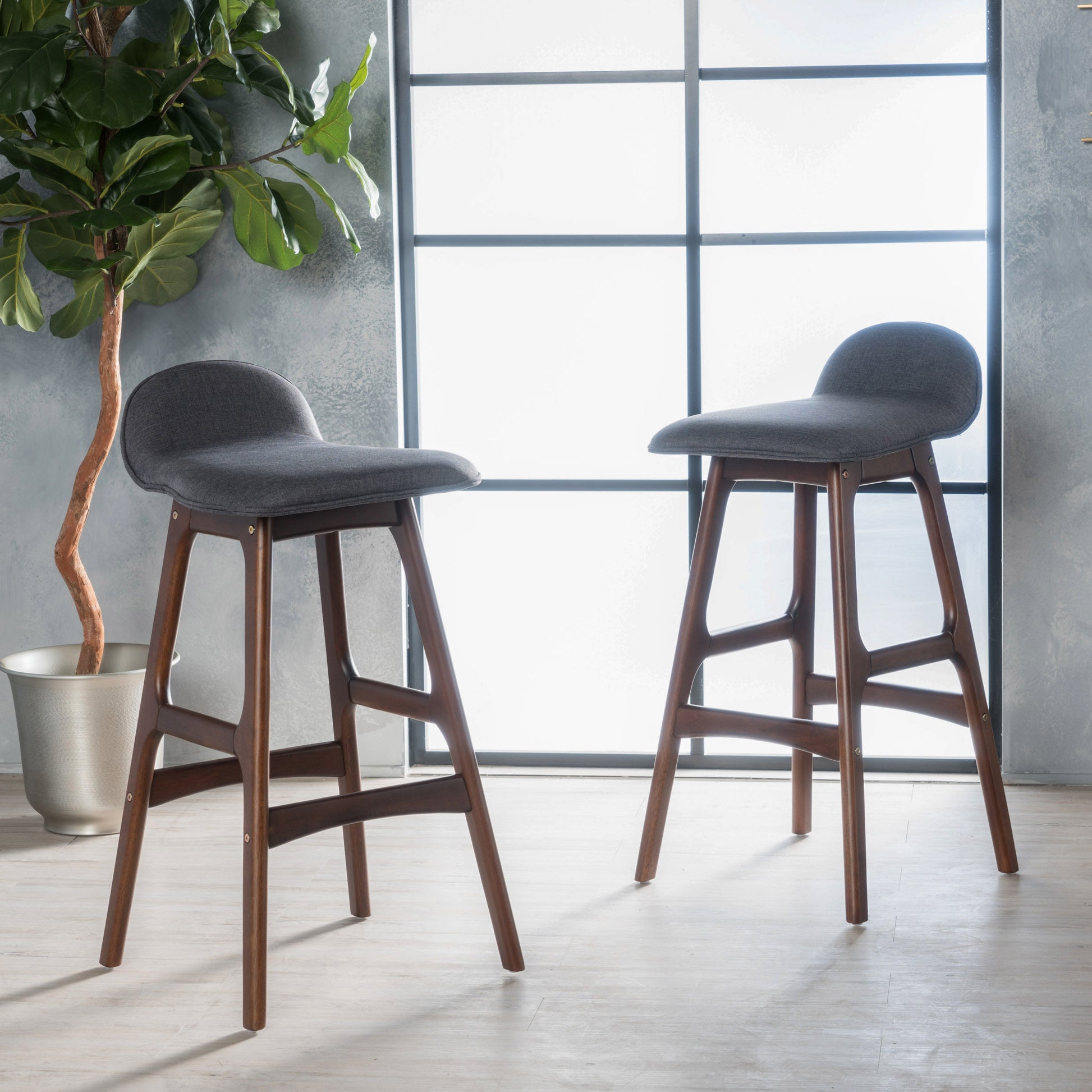 Dark grey upholstered bar stool with walnut wood legs midcentury modern design