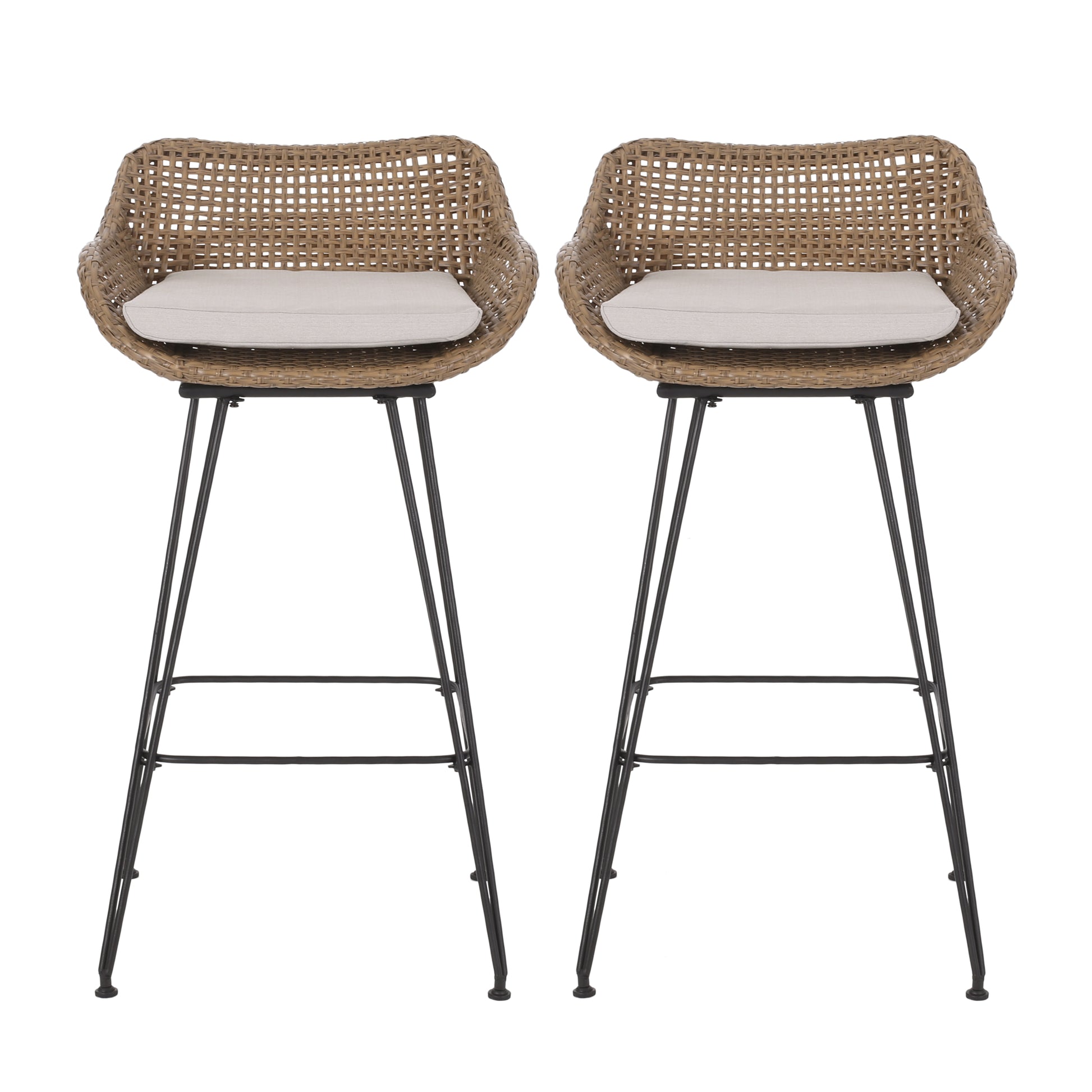 Two tan rattan bar stools with cream cushions and black metal hairpin legs