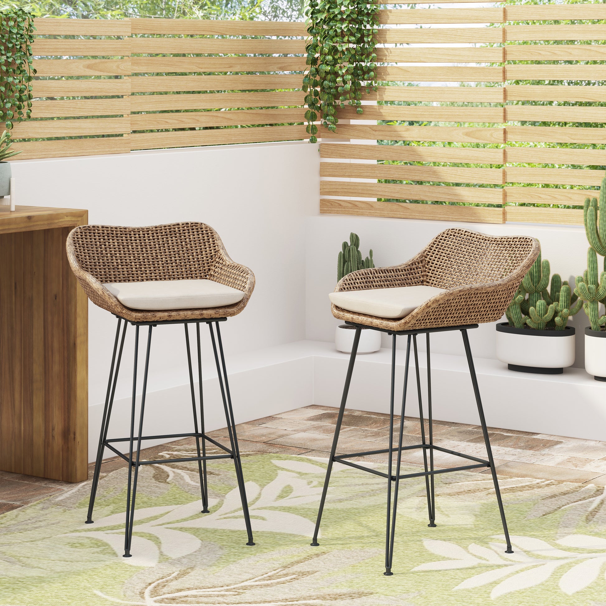 Brown rattan bar stool with cream cushion and black metal legs on outdoor patio
