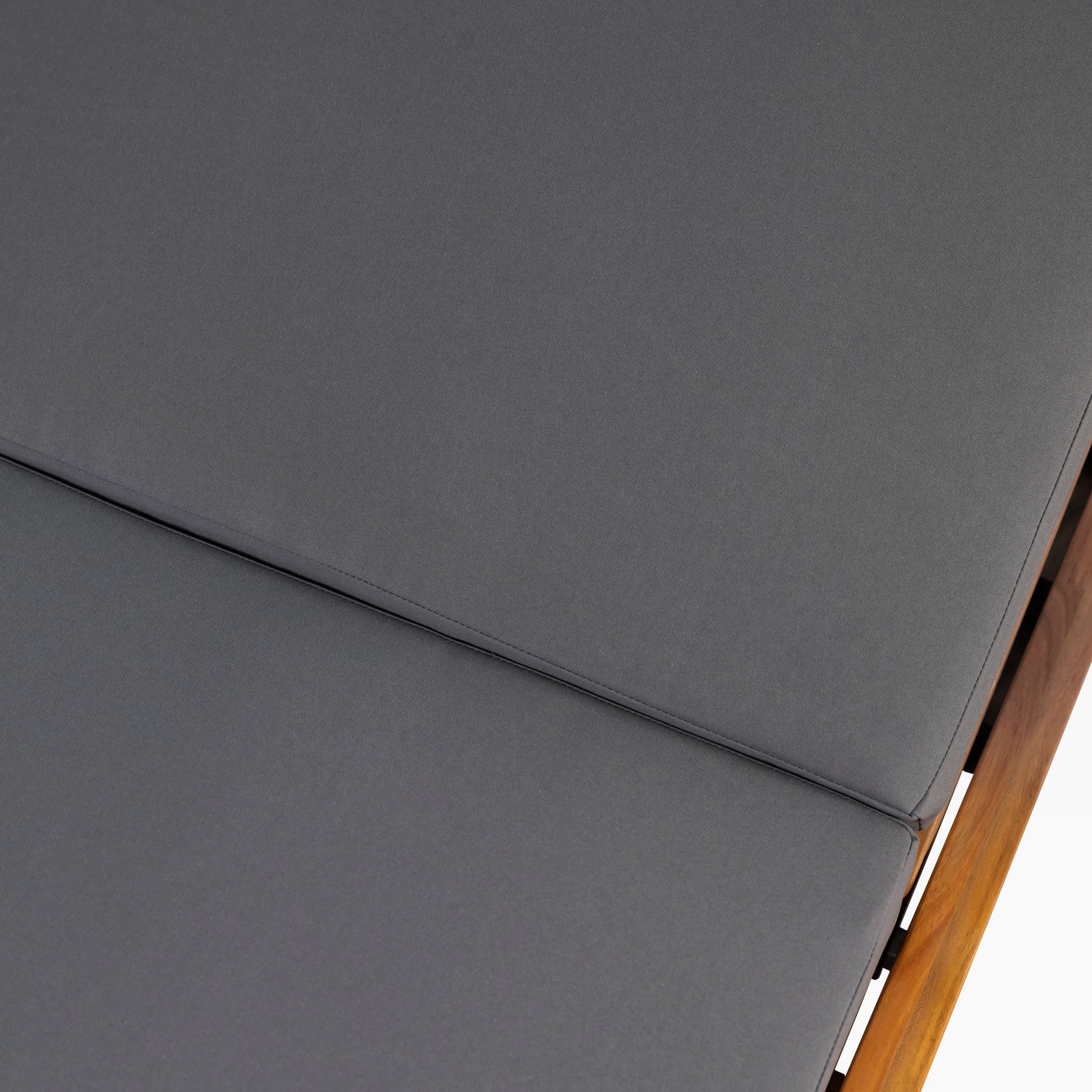 Closeup of charcoal grey outdoor cushion with subtle texture featuring stitched seam detail