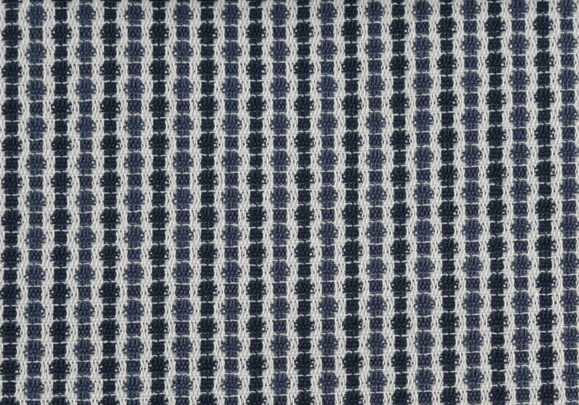 Navy and white textured woven fabric with small geometric pattern