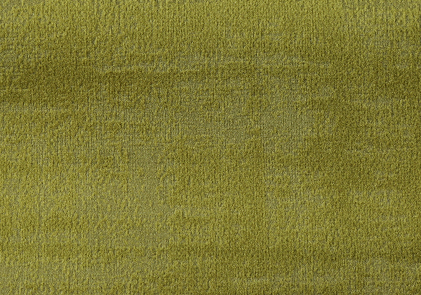 Closeup of plush lime green velvet fabric with a soft textured pile