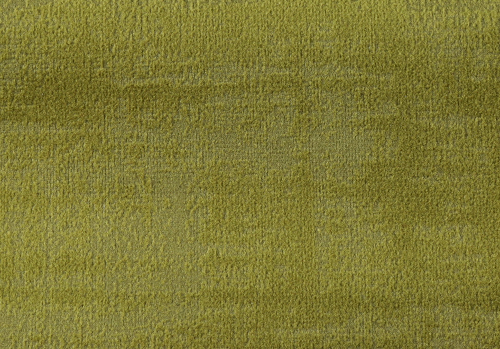 Closeup of plush lime green velvet fabric with a soft textured pile