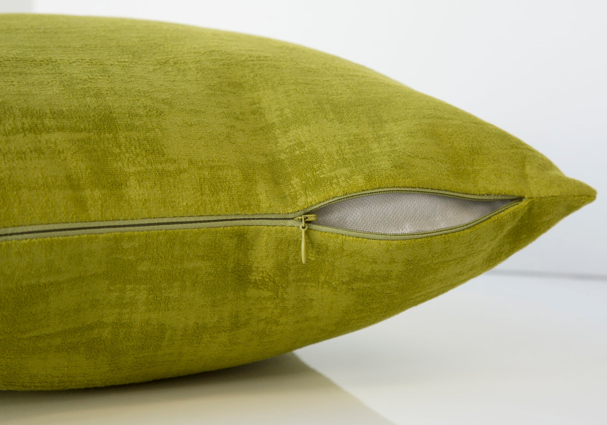 Textured lime green velvet pillow with visible zipper detail