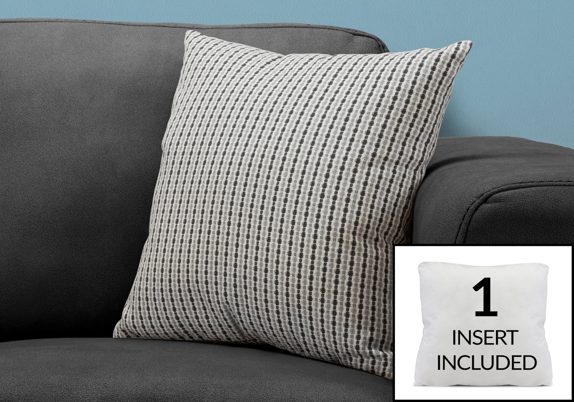 Accent pillow with grey and white geometric pattern on dark grey sofa