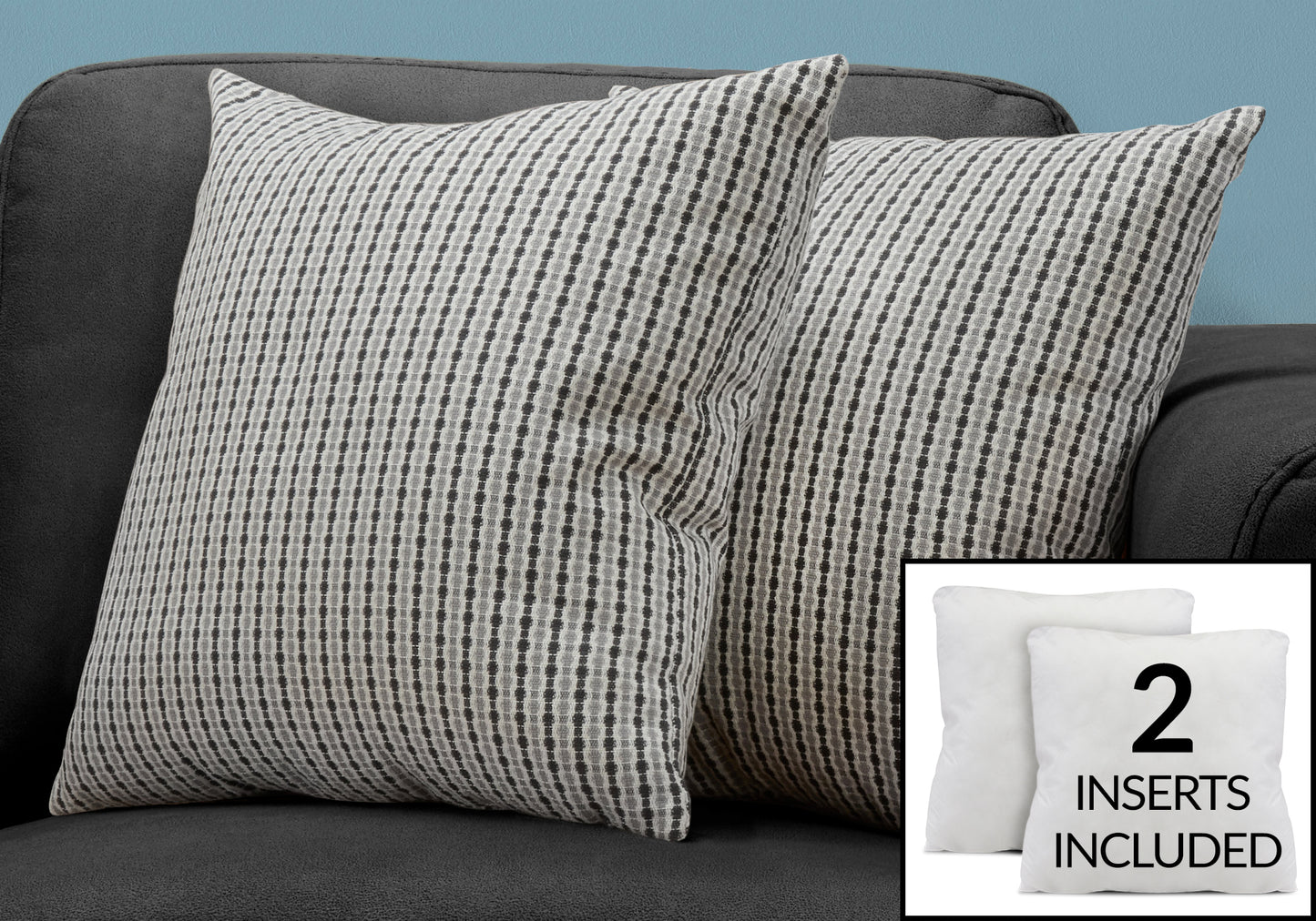 Two striped decorative throw pillows in gray and white on a dark sofa