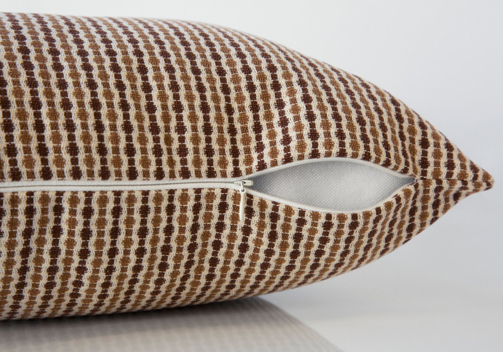 Brown and cream textured decorative pillow with open zipper detail