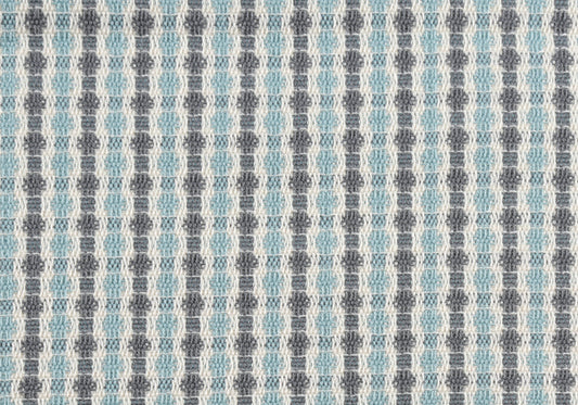 Closeup of geometric woven fabric in light blue and grey diamond pattern