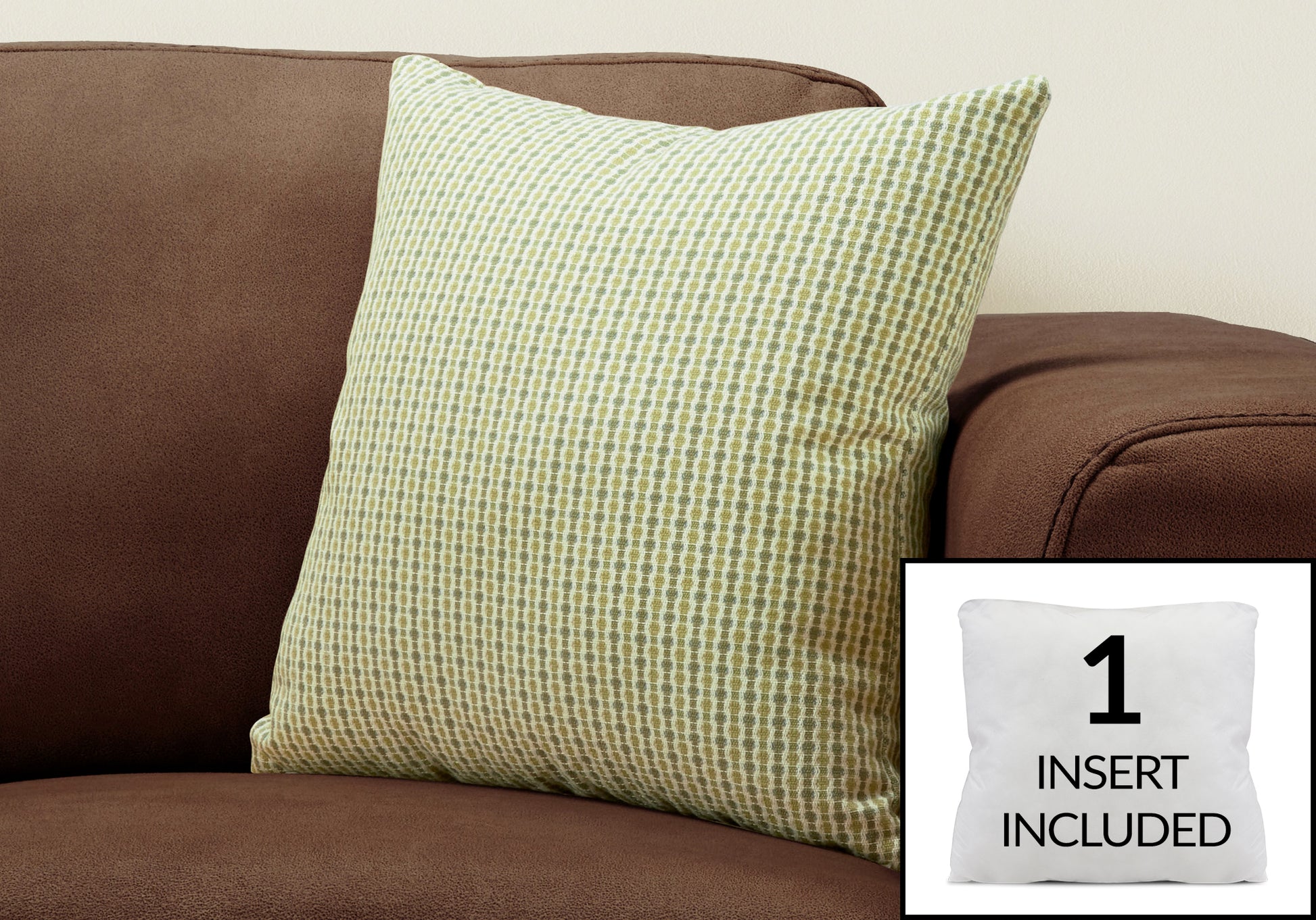 Green and white textured throw pillow on a brown sofa