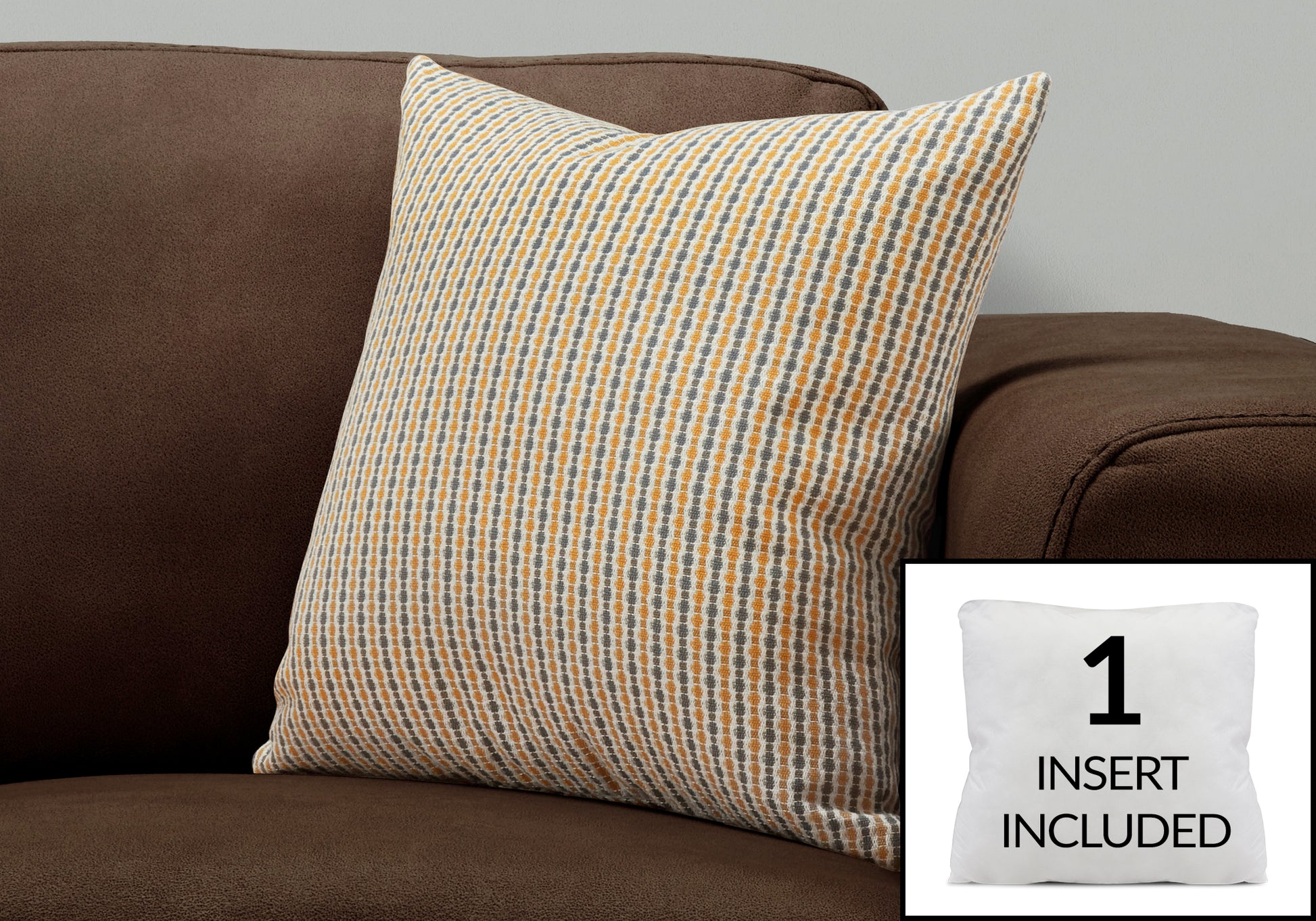 Striped decorative pillow with orange and gray patterns on a brown couch