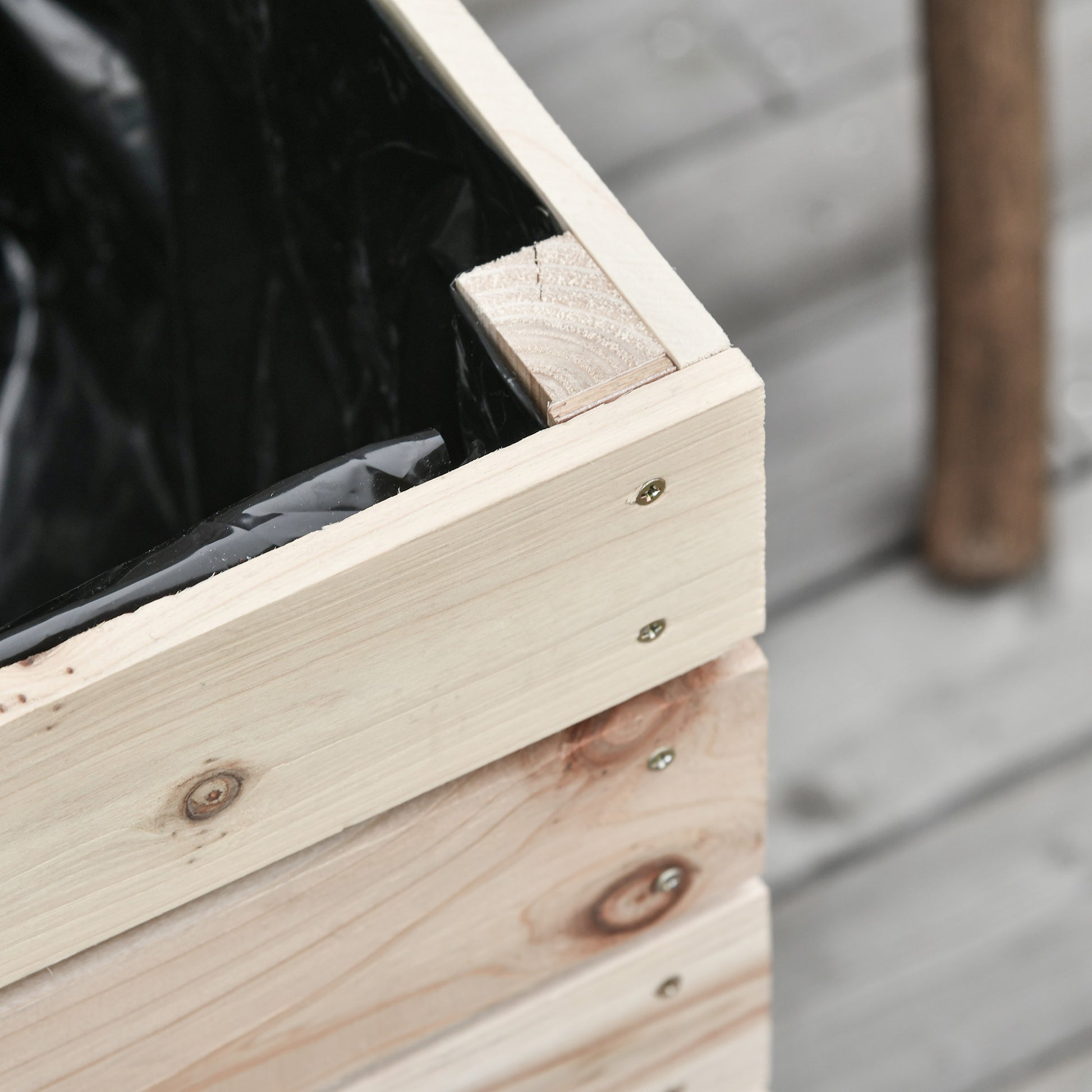 Unfinished pine planter box with black liner and visible screw details