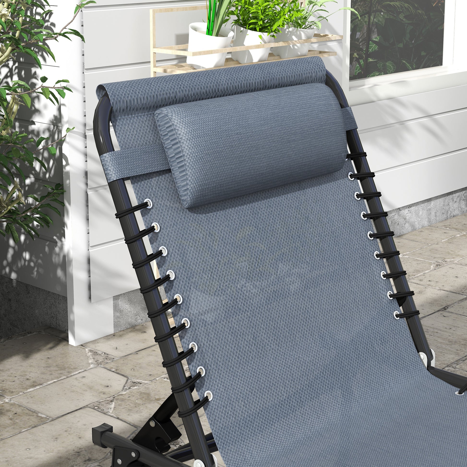 Gray zero gravity chair with padded headrest and black bungee cords for patio relaxation