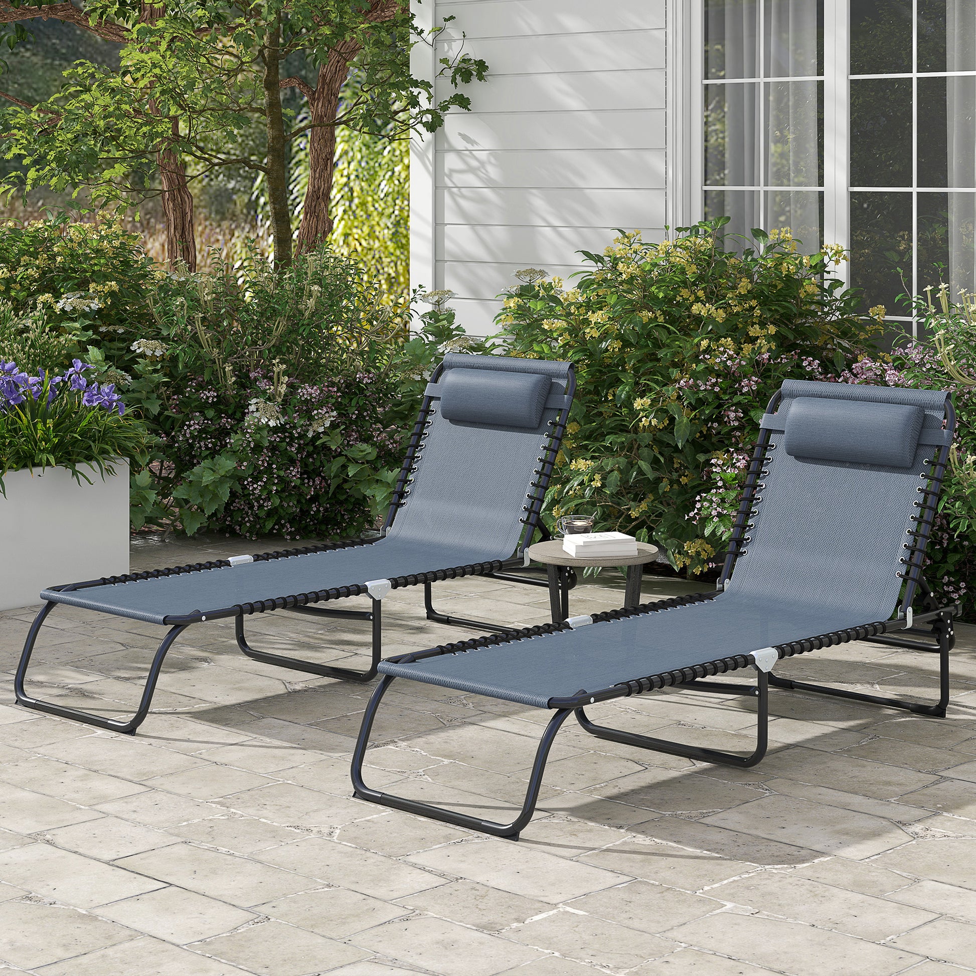 Two gray fabric lounge chairs with black metal frames on a patio perfect for outdoor relaxation