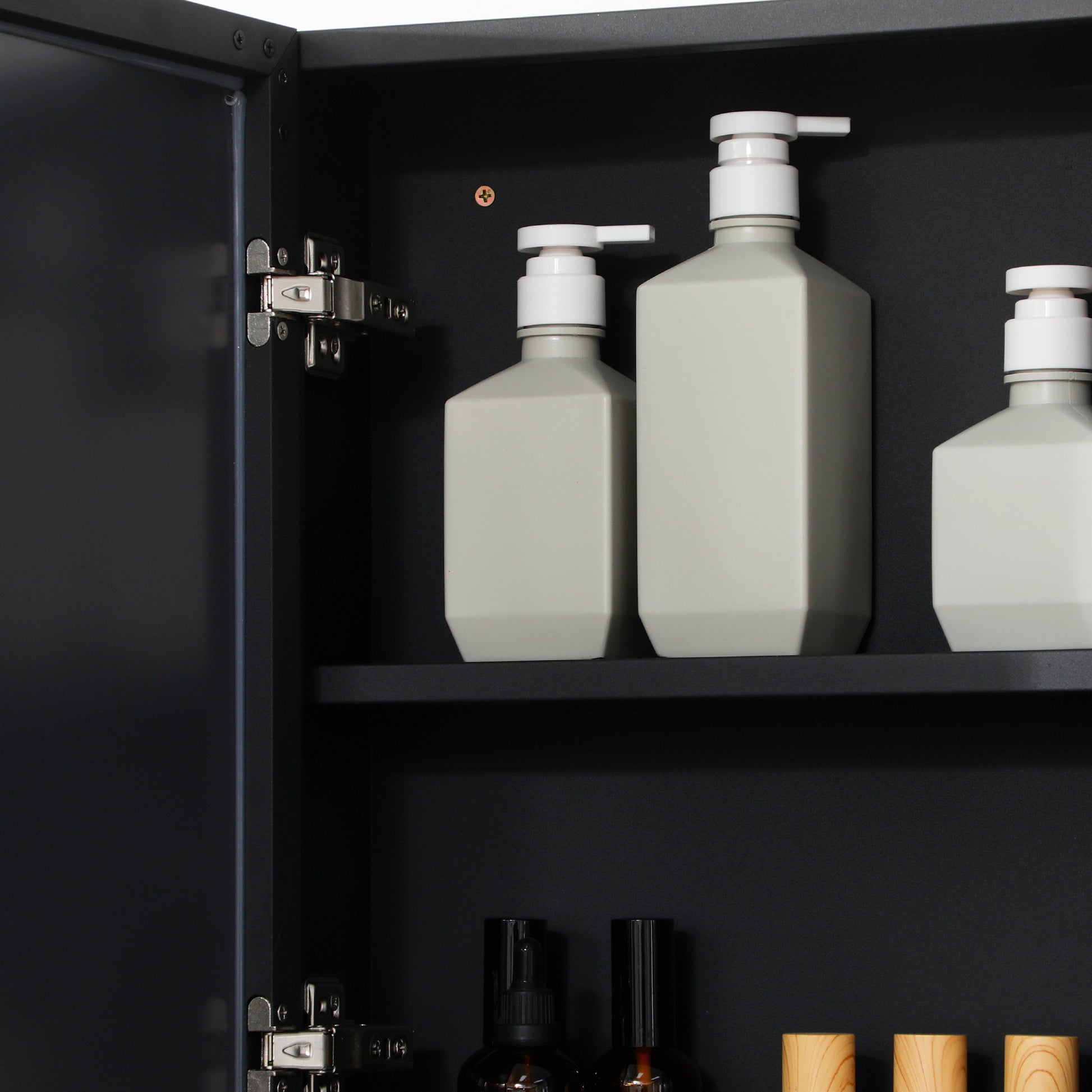 Gray pump bottles for shampoo and conditioner with white pump dispensers neatly arranged on a shelf