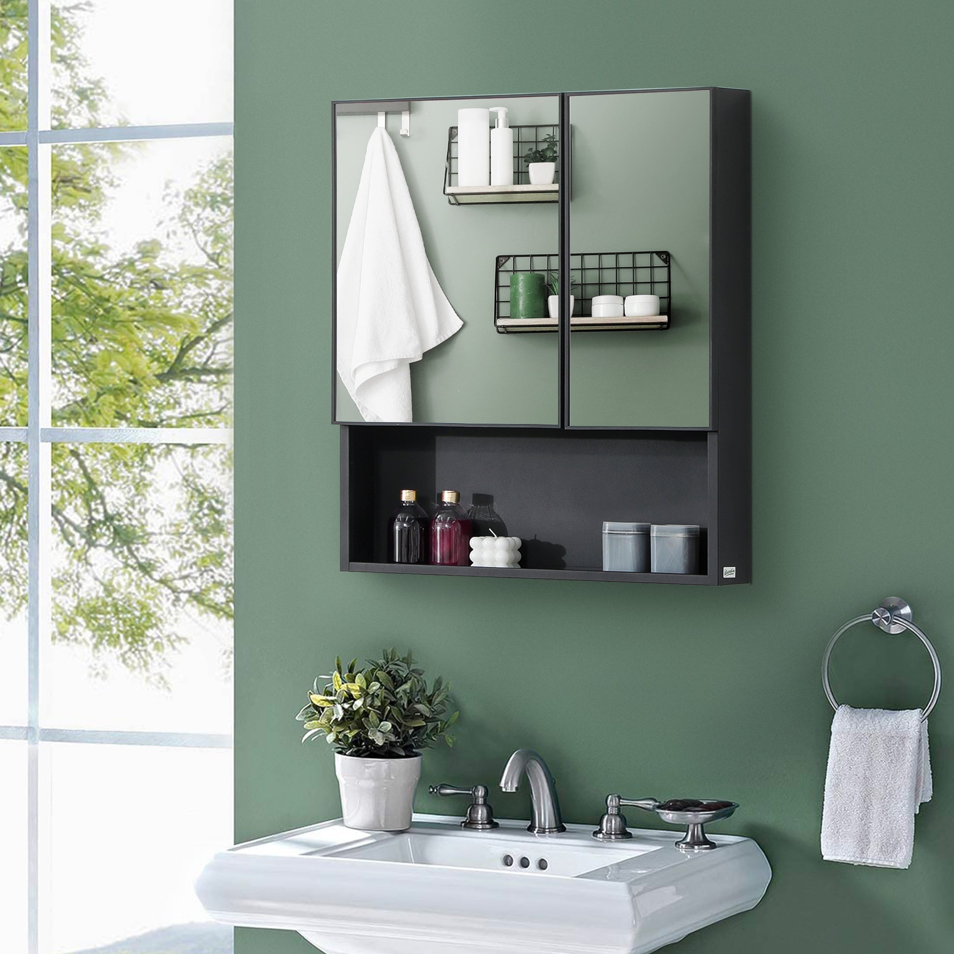 Modern black bathroom medicine cabinet with mirrored doors white towels and toiletries