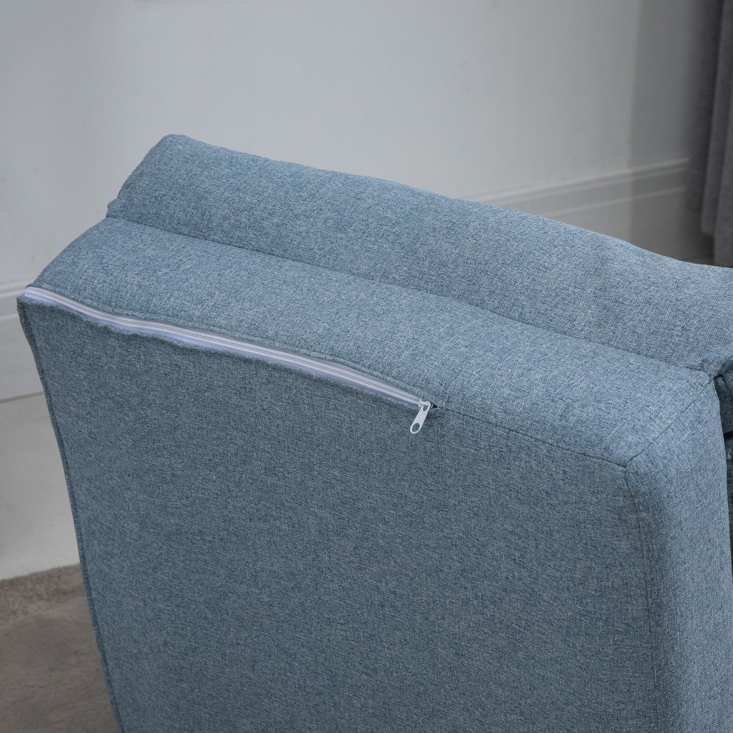 Blue upholstered sofa with a subtle zipper detail on the side cushion  characters