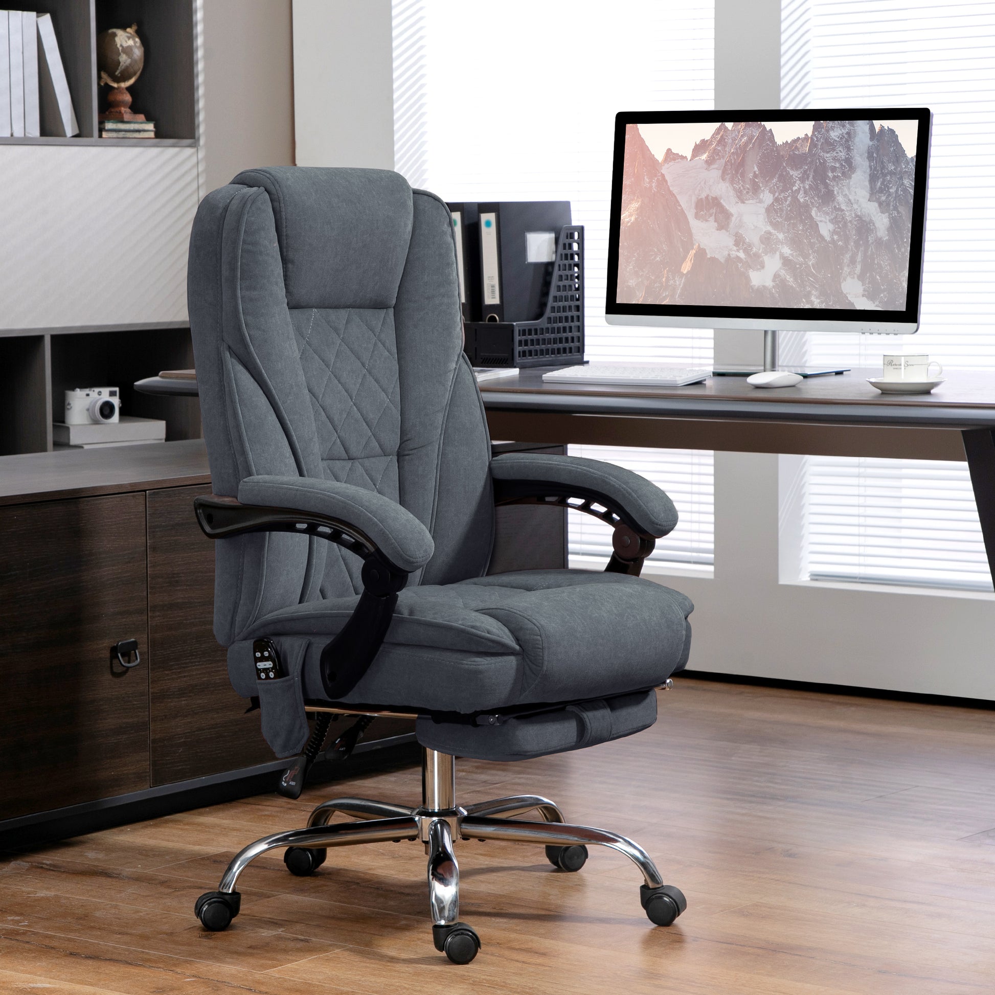Gray executive office chair with retractable footrest and diamond stitching