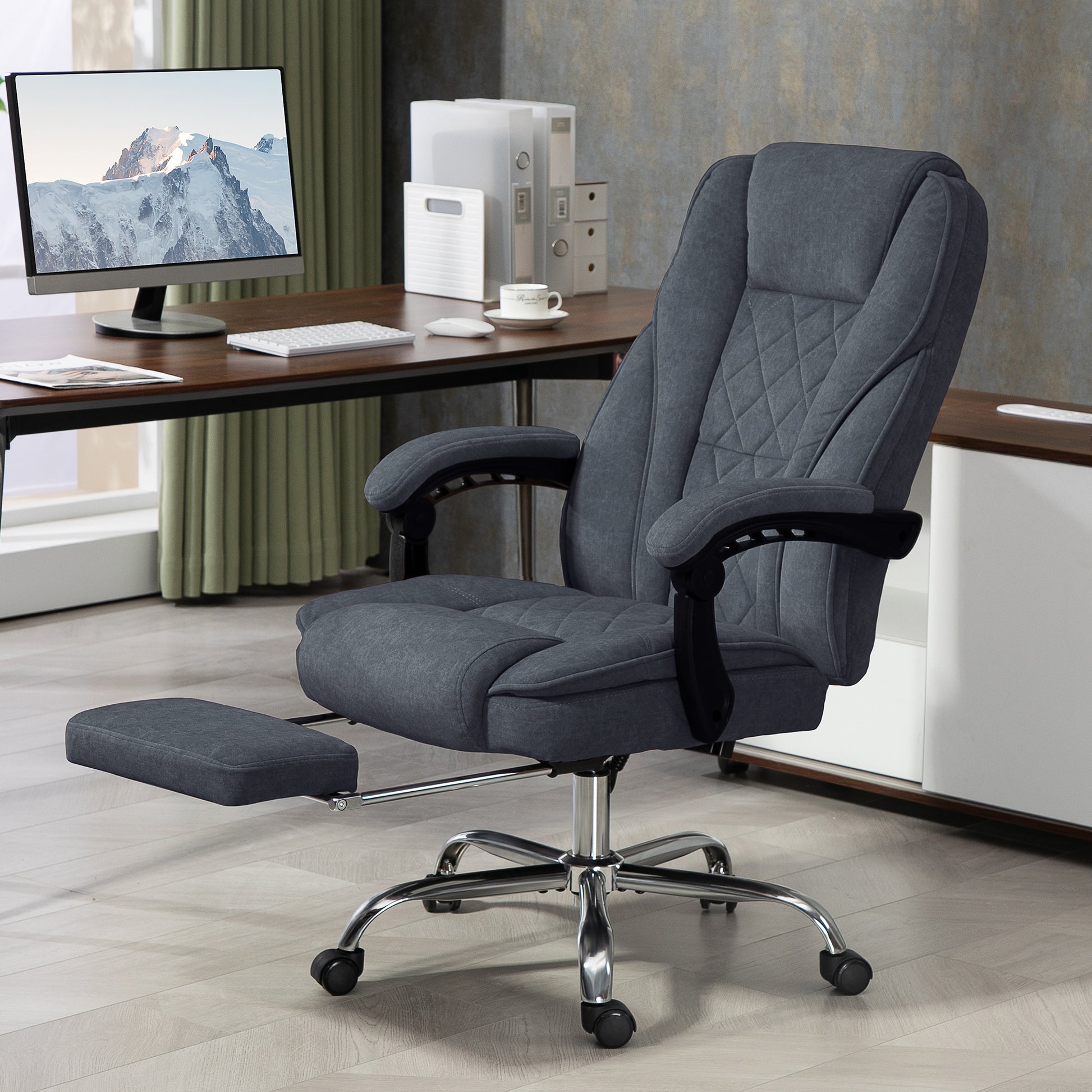 Executive office chair in charcoal grey fabric with diamond stitching and builtin footrest