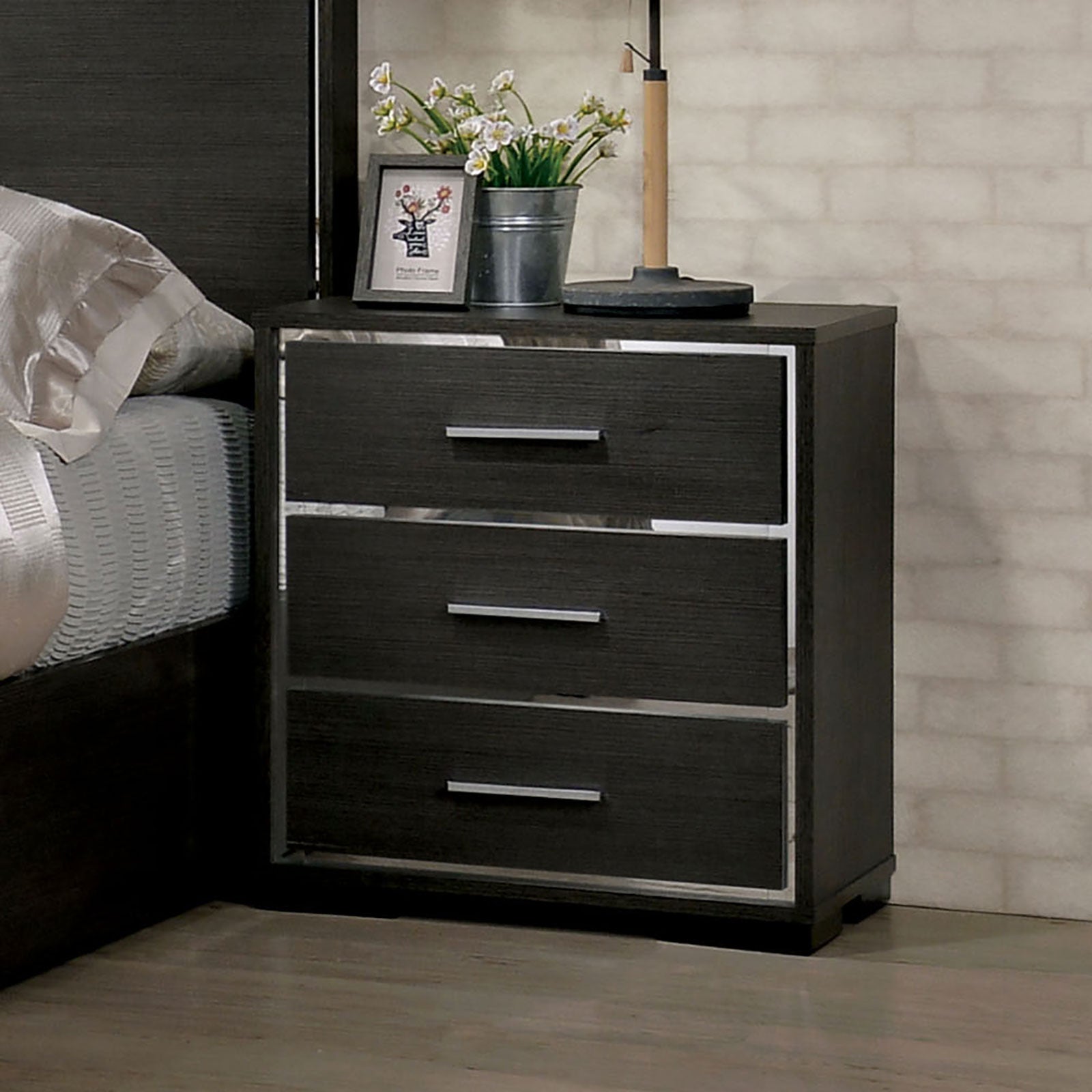Dark wood nightstand with three drawers and silver hardware