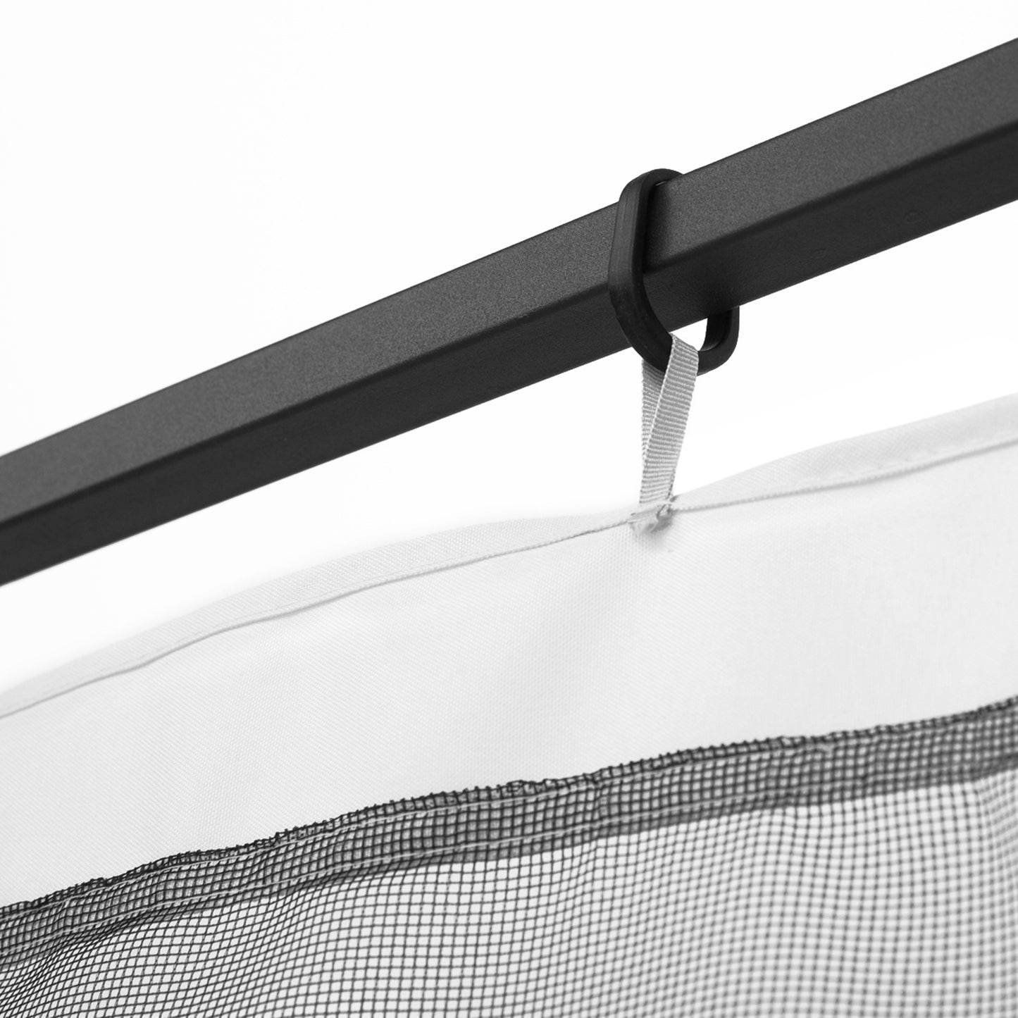Black metal curtain rod with hook and grey fabric loop holding a white mosquito net