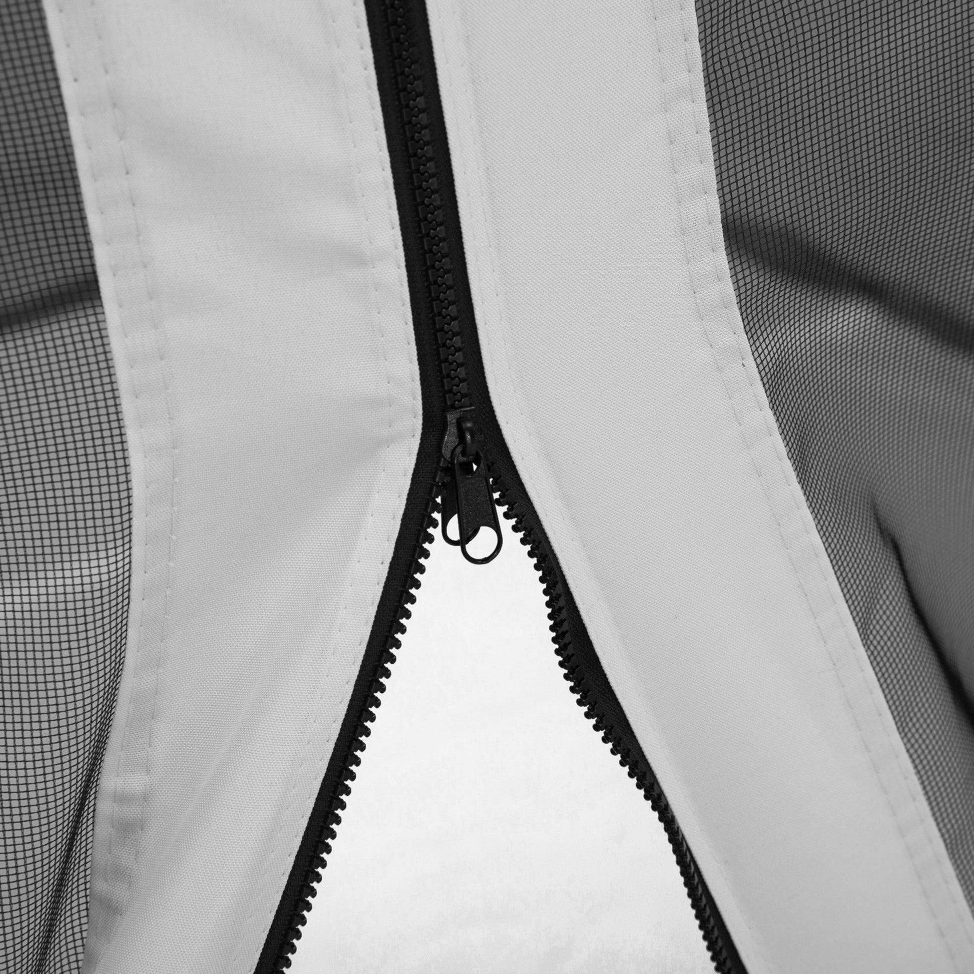 Closeup of a black zipper and white fabric on a mesh screen tent